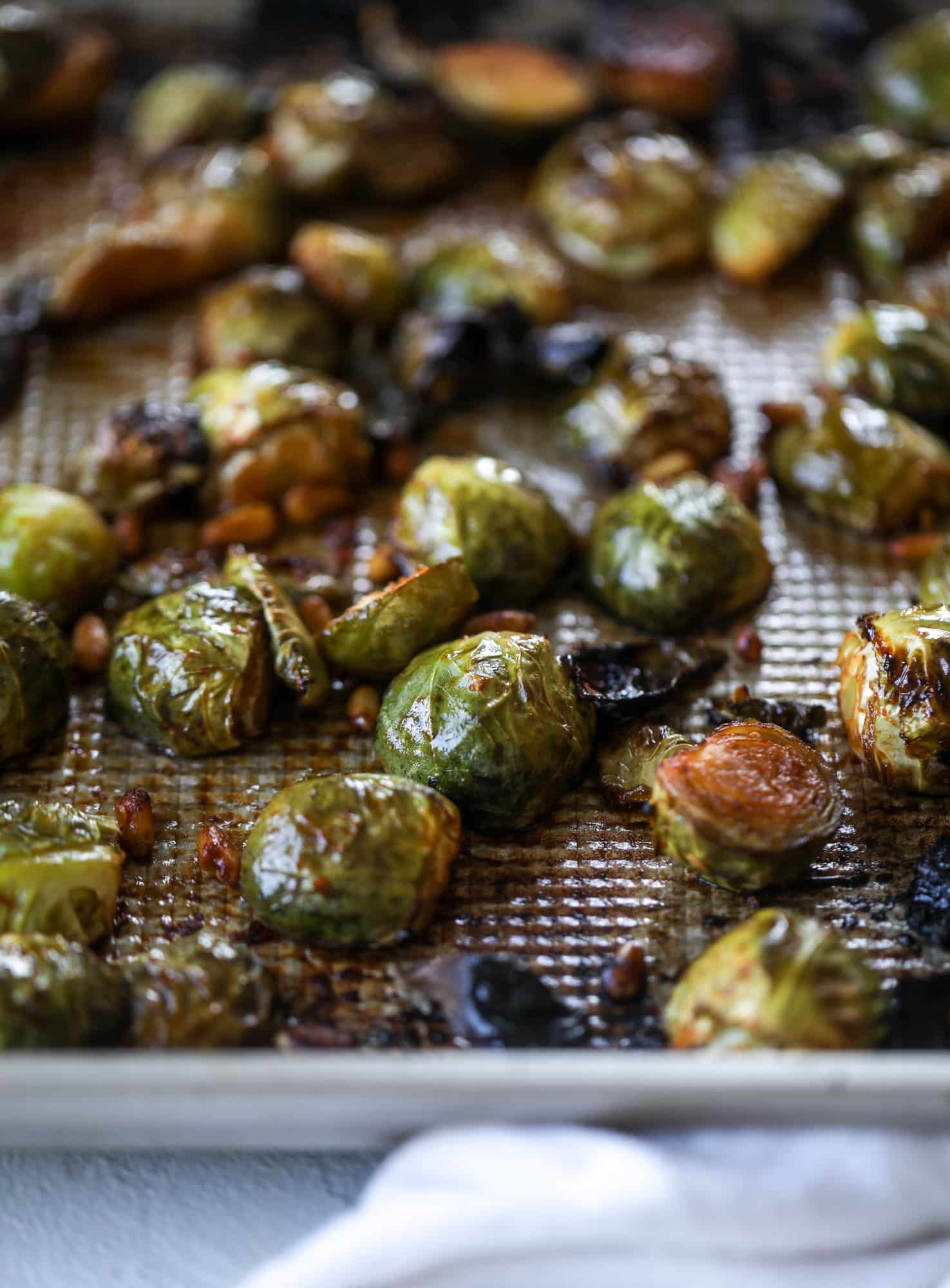 These sweet and spicy brussels sprouts are roasted to perfect and the most delicious side dish! It's a great way to elevate regular old brussels sprouts and make a fantastic side to to serve on a weeknight! I howsweeteats.com #spicy #brusselssprouts