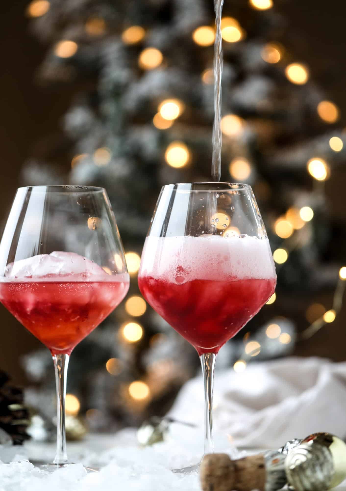 This winter aperol spritz cocktail is a seasonal spin on the classic aperol spritz! Festive cranberry and classic orange come together with prosecco and club soda to create a super light and refreshing cocktail for the holidays! I howsweeteats.com #aperol #spritz
