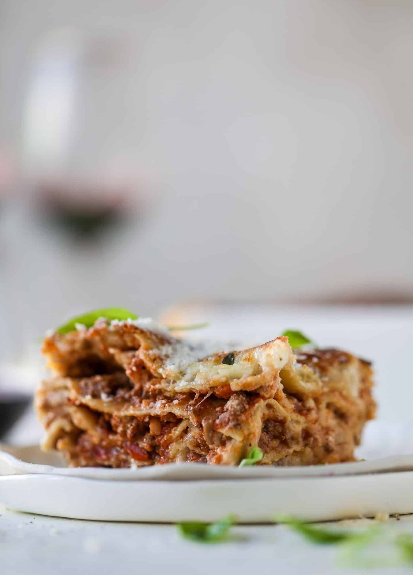 This lasagna bolognese is the ultimate comfort food. Meaty sauce, whole wheat lasagna noodles, creamy bechamel and grated cheese come together to create the most perfect slice of lasagna heaven! I howsweeteats.com #lasagna #bolognese