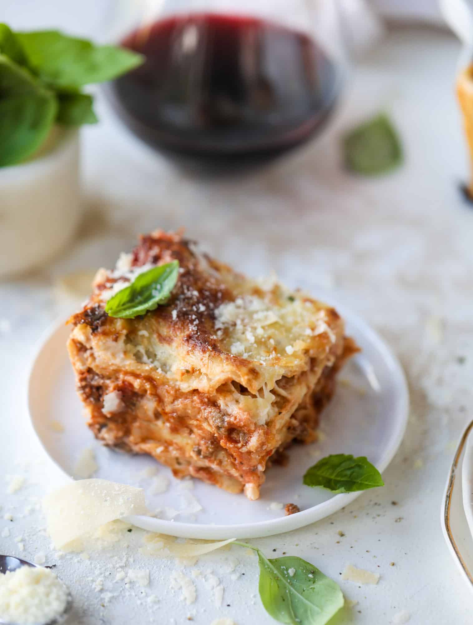 This lasagna bolognese is the ultimate comfort food. Meaty sauce, whole wheat lasagna noodles, creamy bechamel and grated cheese come together to create the most perfect slice of lasagna heaven! I howsweeteats.com #lasagna #bolognese