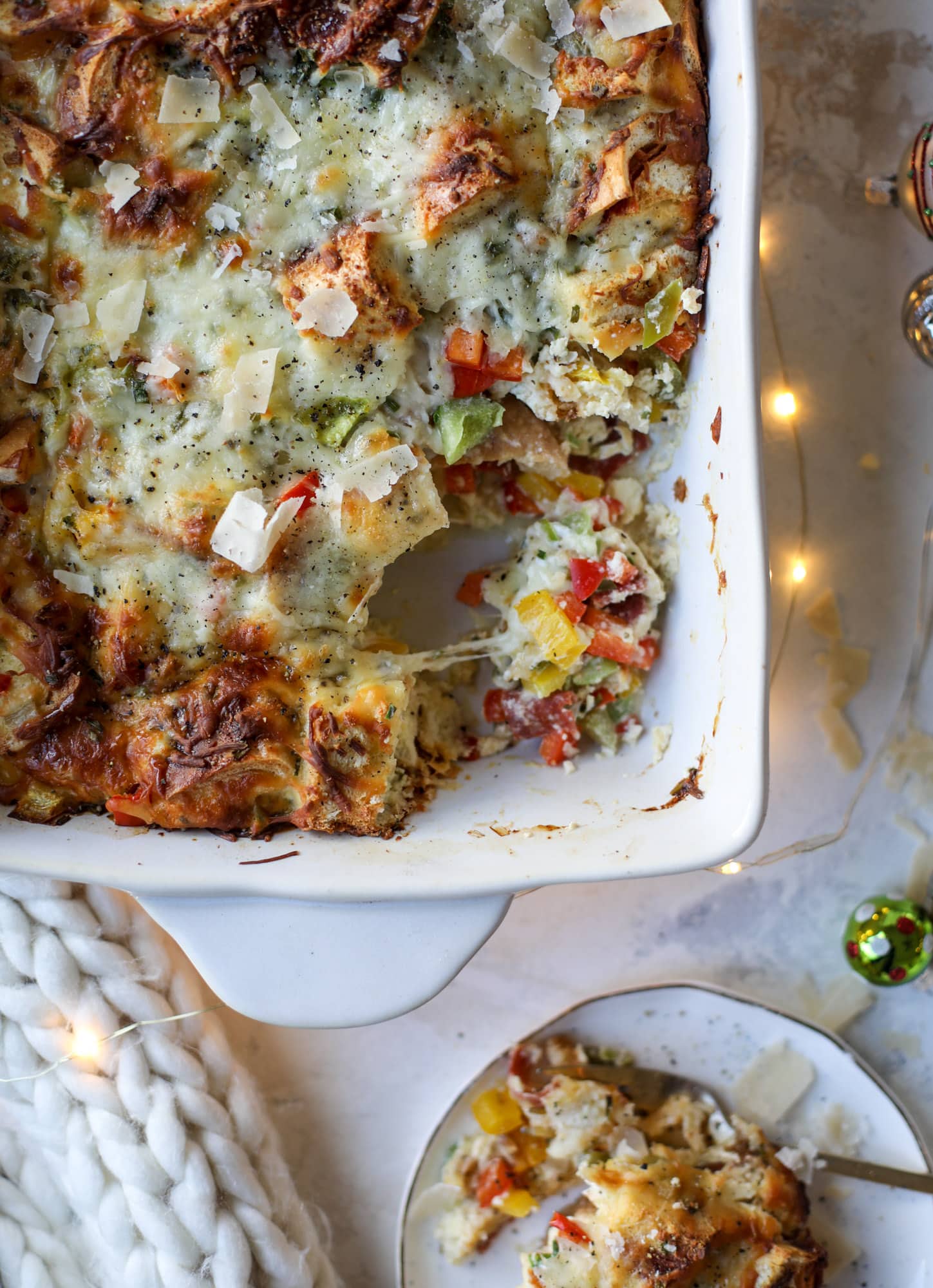 This breakfast strata is super special because the base is built on pepperoni rolls! This make ahead casserole is perfect for holiday brunches or parties and tastes like a supreme pizza. It's so easy to throw together too! I howsweeteats.com #breakfast #strata