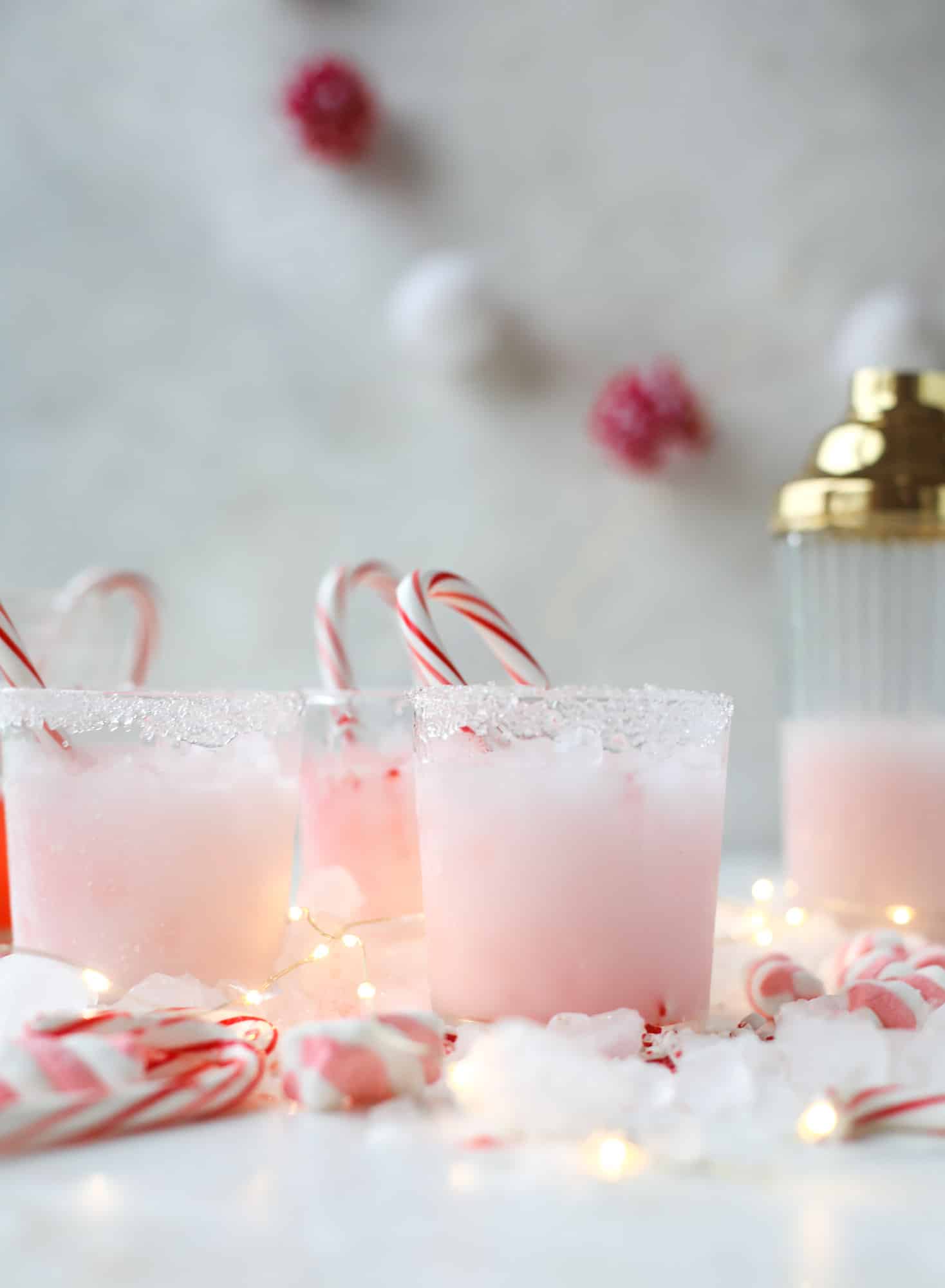 This pink peppermint cocktail is full of holiday cheer! Candy cane vodka, creme de cacao, vanilla and a drop of cream come together to create the perfect iced holiday drink that tastes like a treat! I howsweeteats.com #pinkpeppermint #cocktail