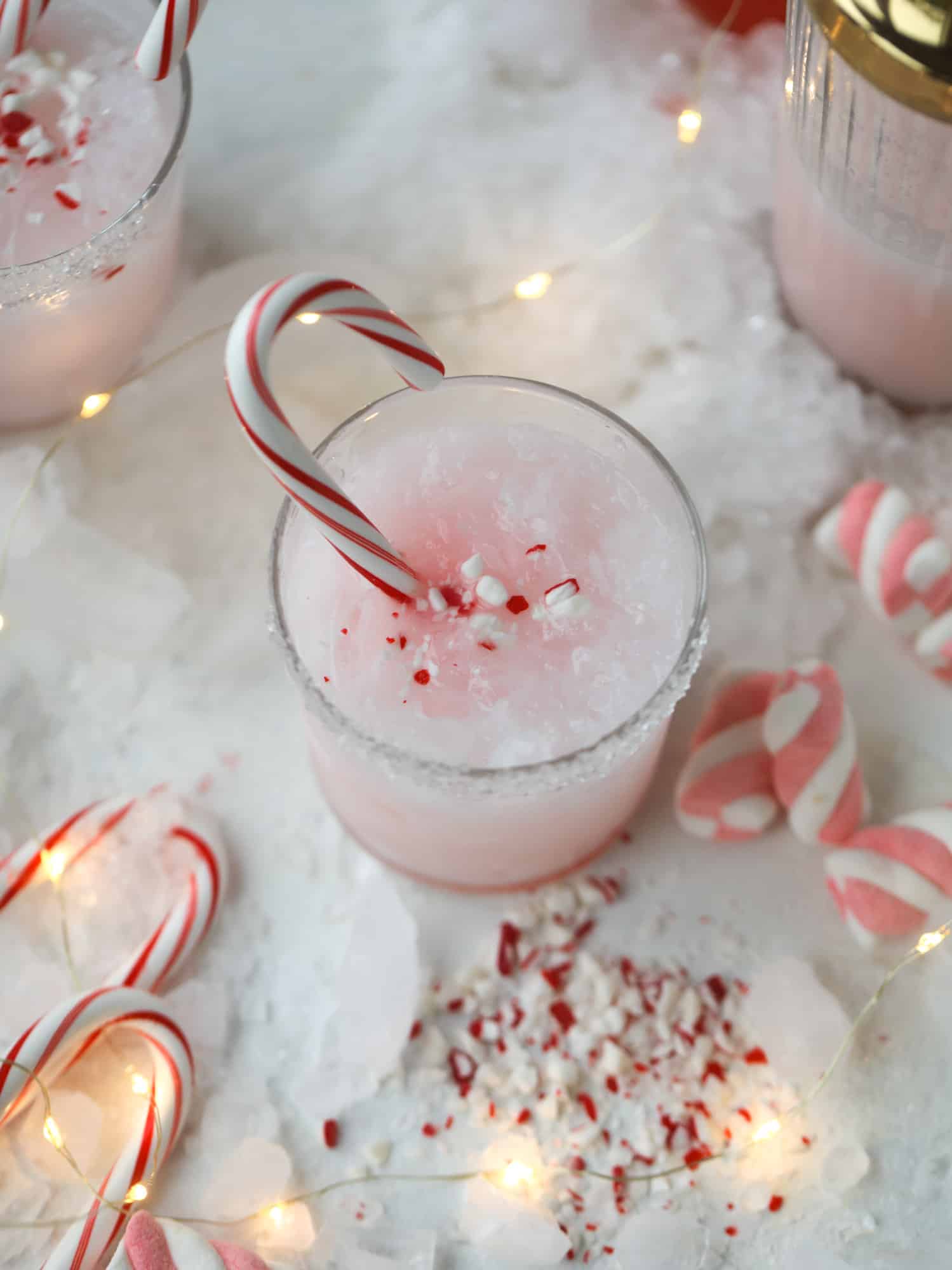 This pink peppermint cocktail is full of holiday cheer! Candy cane vodka, creme de cacao, vanilla and a drop of cream come together to create the perfect iced holiday drink that tastes like a treat! I howsweeteats.com #pinkpeppermint #cocktail