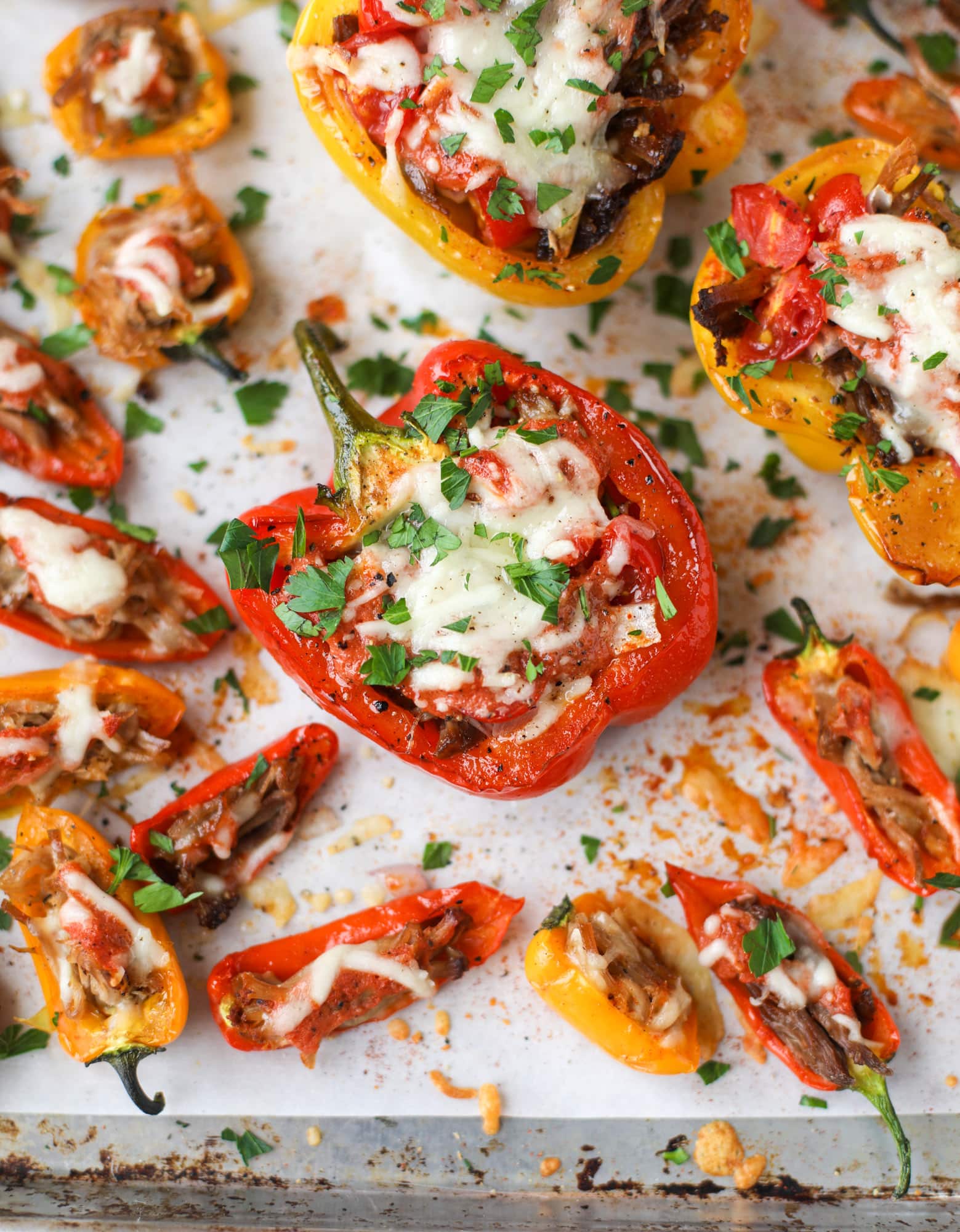 These pulled pork stuffed peppers are a delicious dinner idea for any weeknight! They work great with leftover pulled pork and the filling is totally customizable. They are flavorful, come together quickly and always a crowd pleaser! I howsweeteats.com #pulledpork #stuffedpeppers