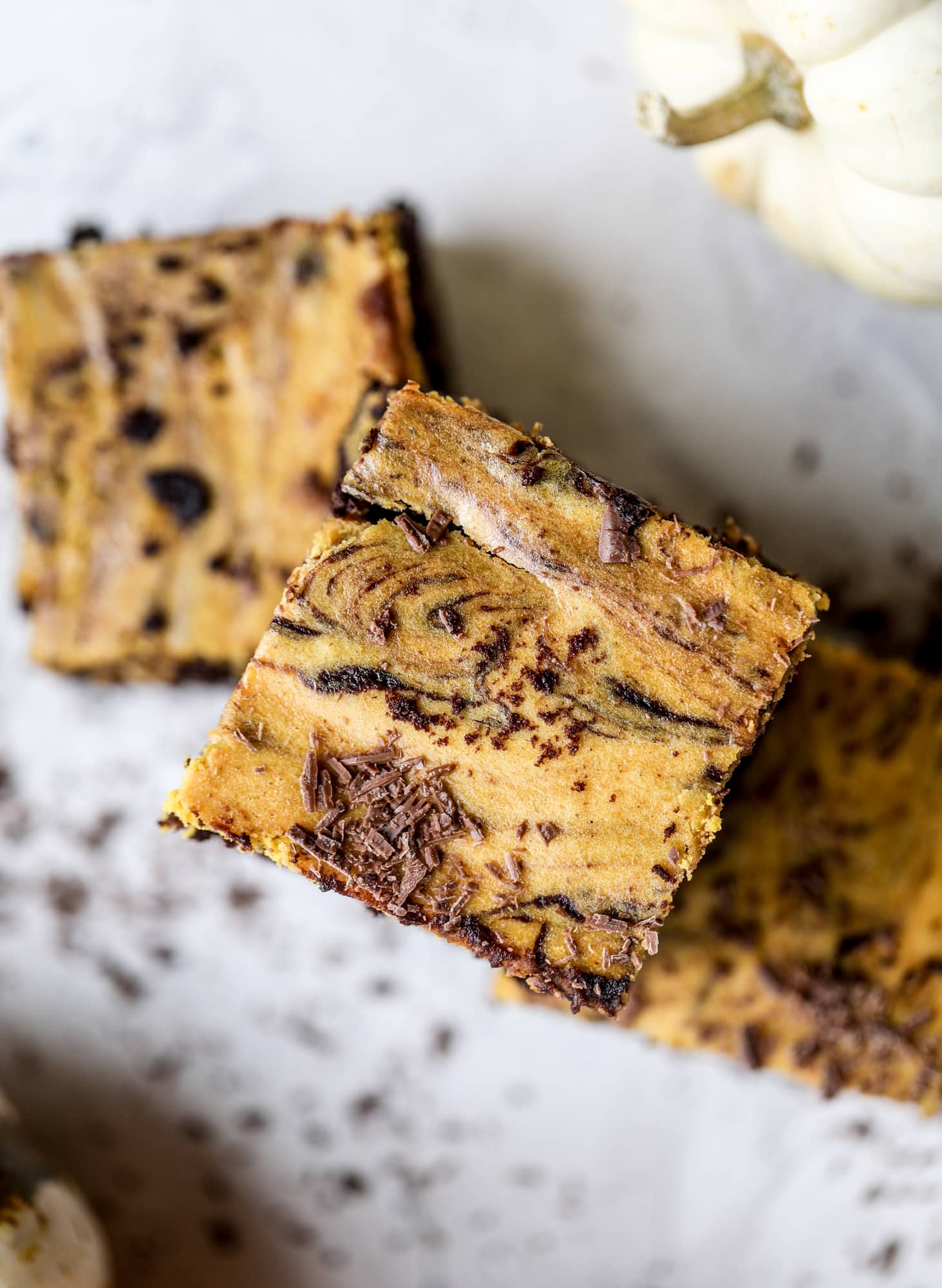 These pumpkin brownies have a fudgy layer of chocolate on the bottom and a silky layer of pumpkin on top! They are so delicious and rich and perfect for fall. The pumpkin brownies come together easily and can be made ahead of time too! I howsweeteats.com #pumpkin #brownies