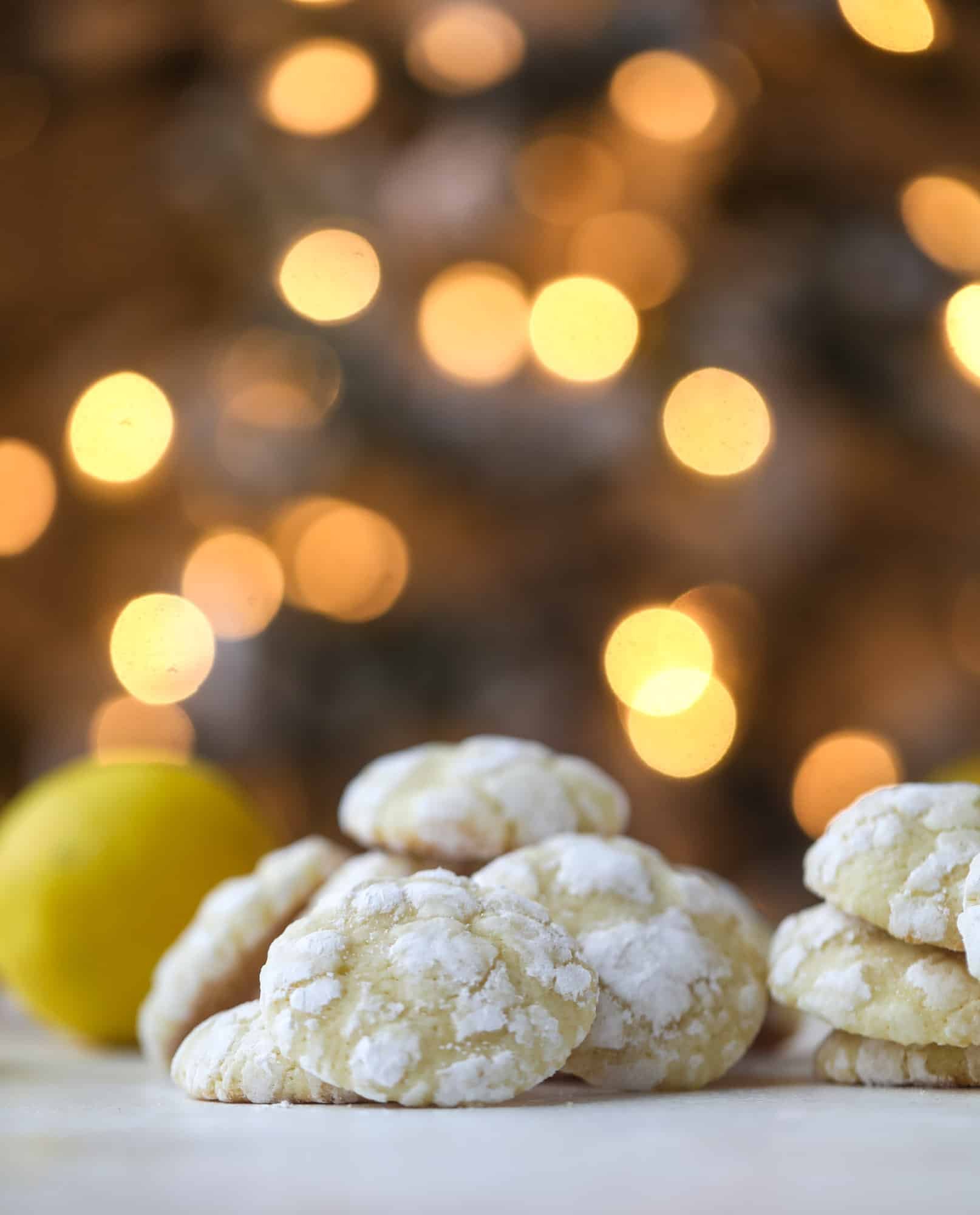These lemon crinkle cookies are perfect if you love lemon desserts! They take after chocolate crinkle cookies, but are a delightful refreshing lemon flavor sprinkle with powdered sugar. These are always a huge hit! I howsweeteats.com #lemoncrinkle #cookies