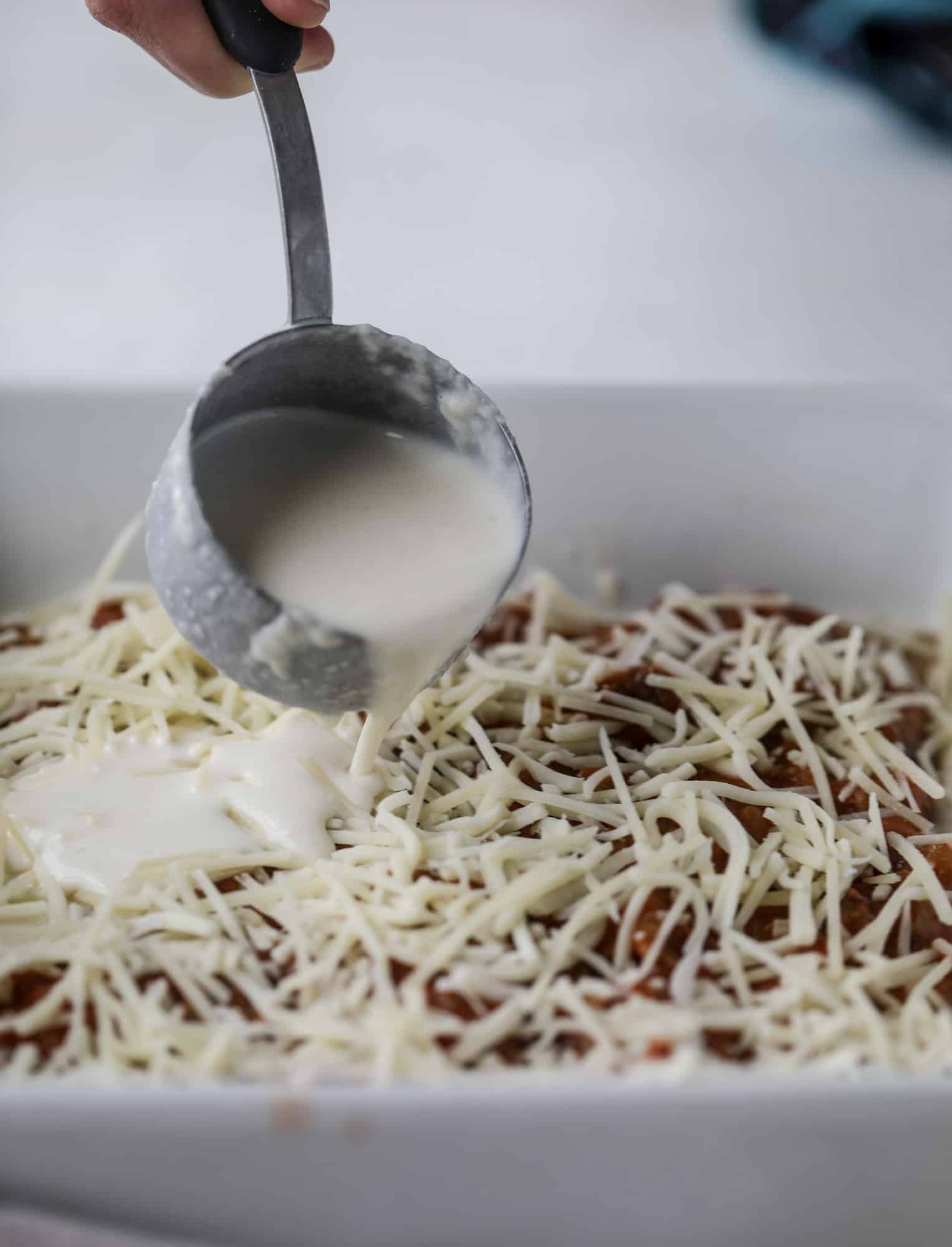 This lasagna bolognese is the ultimate comfort food. Meaty sauce, whole wheat lasagna noodles, creamy bechamel and grated cheese come together to create the most perfect slice of lasagna heaven! I howsweeteats.com #lasagna #bolognese