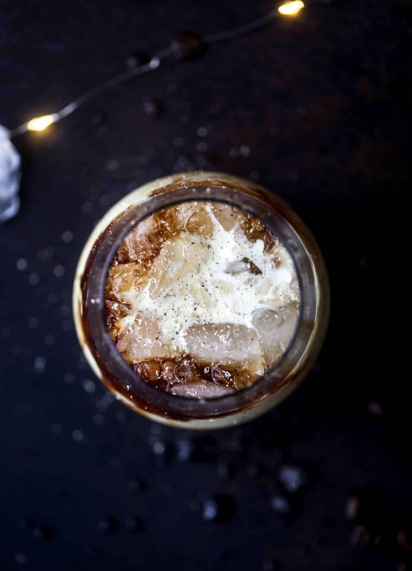 The eggnog white russian cocktail is perfect for the holiday season! Coffee liqueur mixed with vanilla vodka and eggnog and topped with freshly grated nutmeg is the perfect treat and oh-so festive! I howsweeteats.com #eggnog #whiterussian