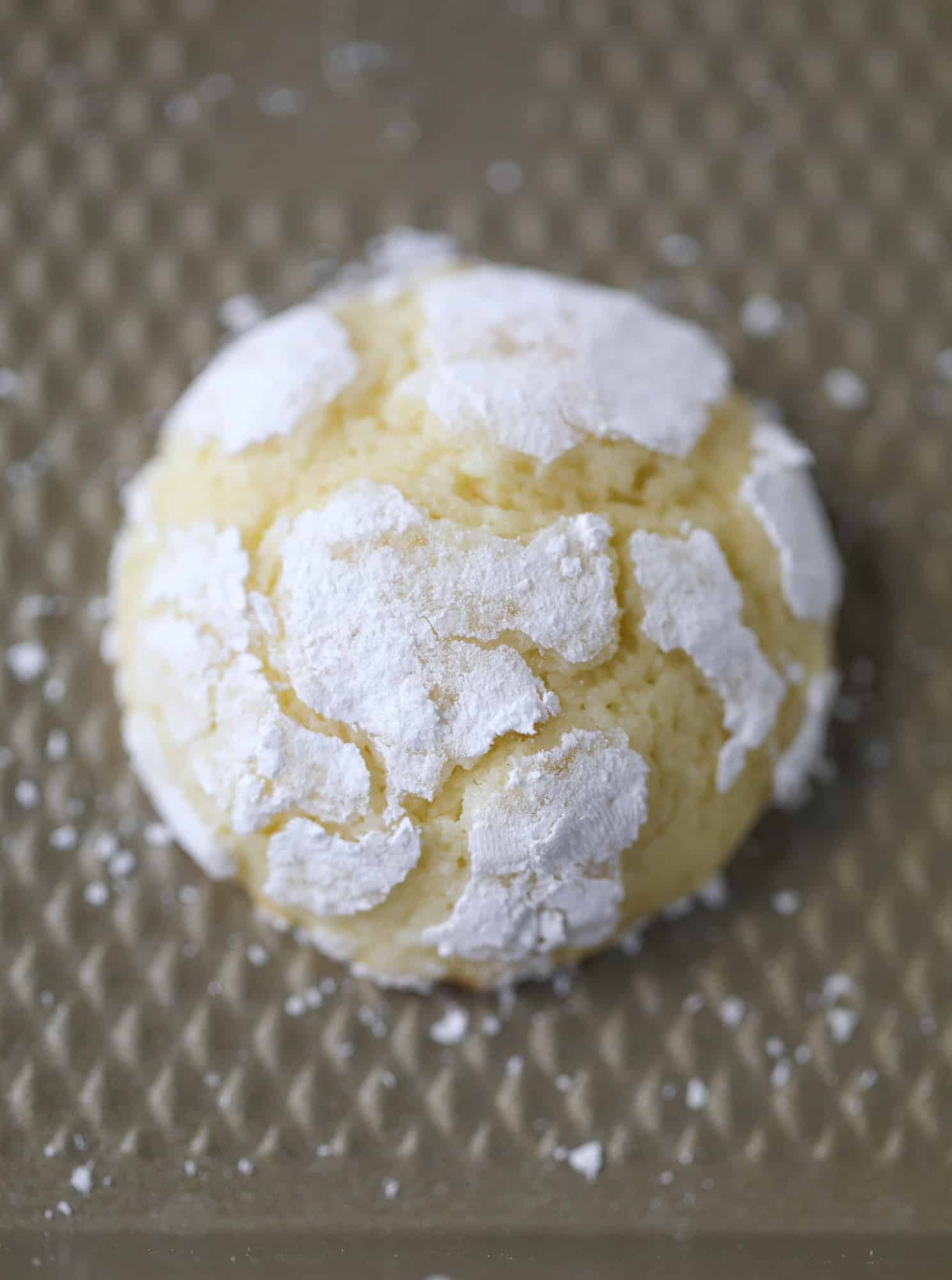 These lemon crinkle cookies are perfect if you love lemon desserts! They take after chocolate crinkle cookies, but are a delightful refreshing lemon flavor sprinkle with powdered sugar. These are always a huge hit! I howsweeteats.com #lemoncrinkle #cookies