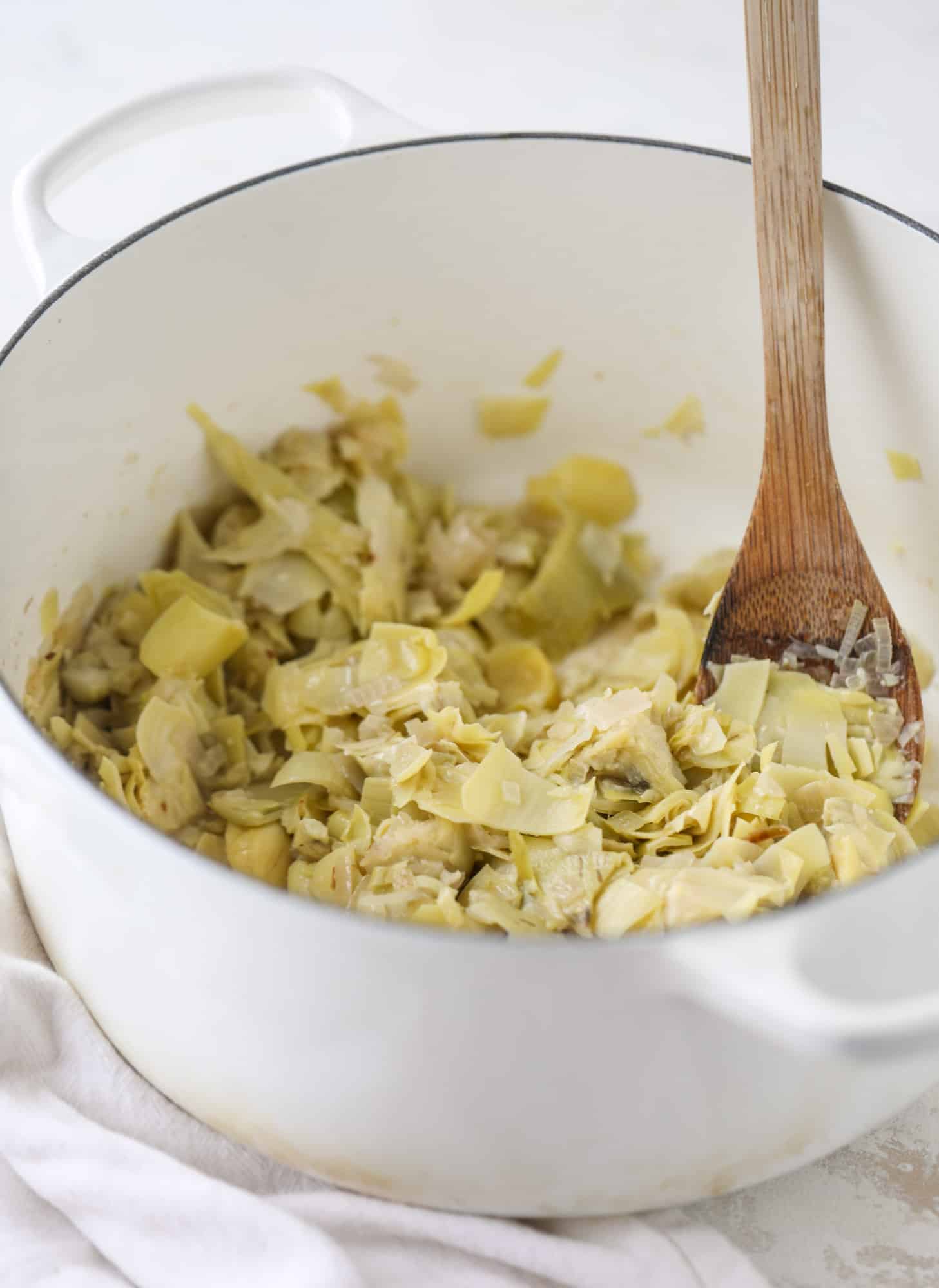  This creamy artichoke soup is full of artichoke hearts, cream and crème fraiche. It's rich and hearty but also light in flavor - perfect for late winter. I howsweeteats.com #artichoke #soup