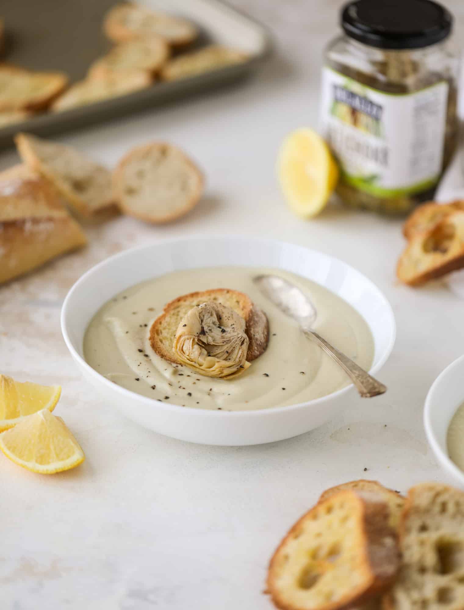  This creamy artichoke soup is full of artichoke hearts, cream and crème fraiche. It's rich and hearty but also light in flavor - perfect for late winter. I howsweeteats.com #artichoke #soup