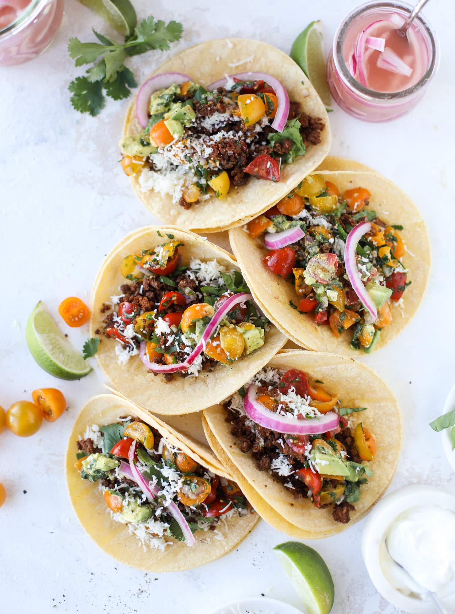 Weeknight ground beef tacos that are anything like the 90s! These are made with a homemade taco seasoning and served with the perfect toppings! I howsweeteats.com #groundbeef #tacos