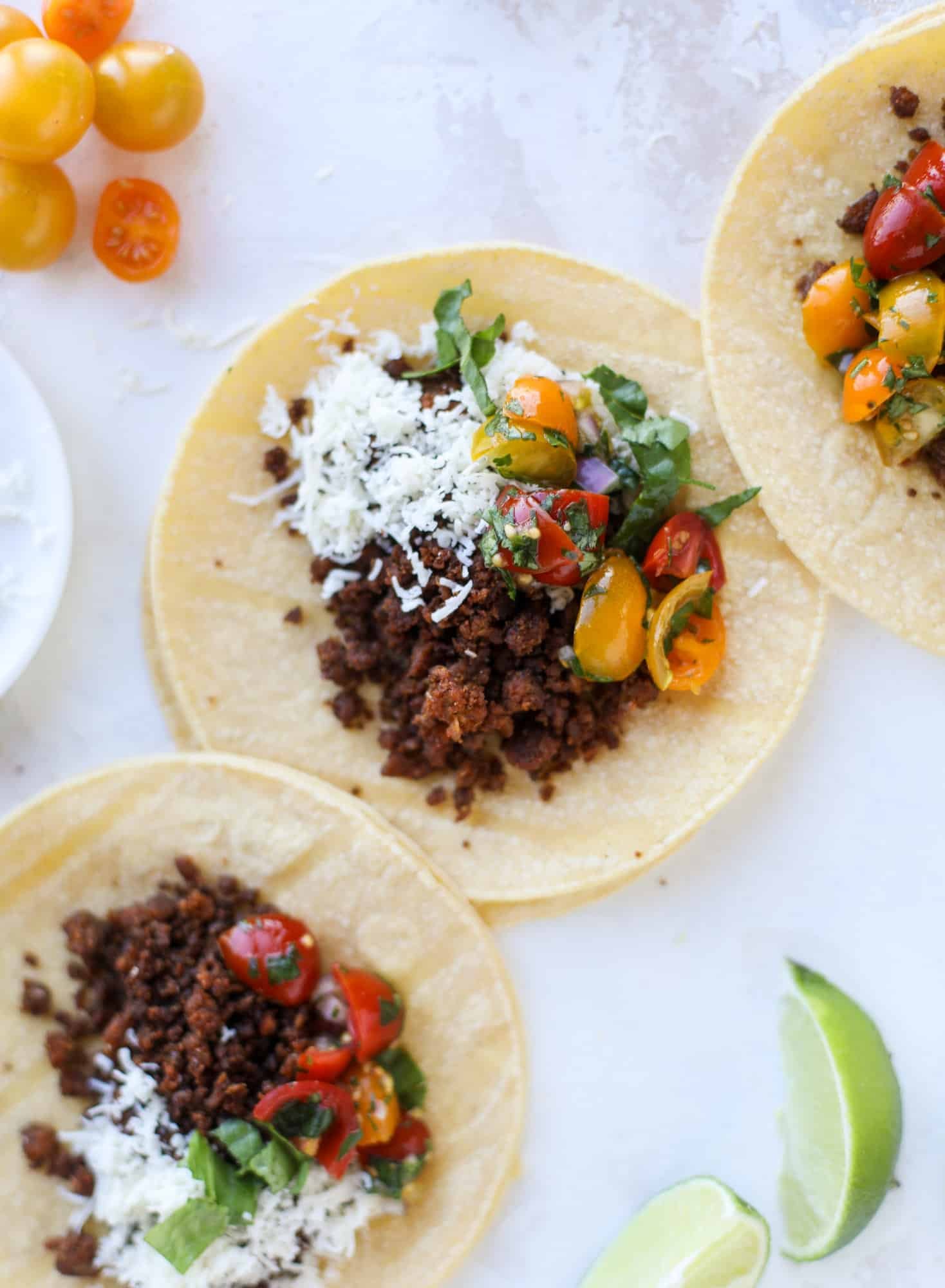 Weeknight ground beef tacos that are anything like the 90s! These are made with a homemade taco seasoning and served with the perfect toppings! I howsweeteats.com #groundbeef #tacos