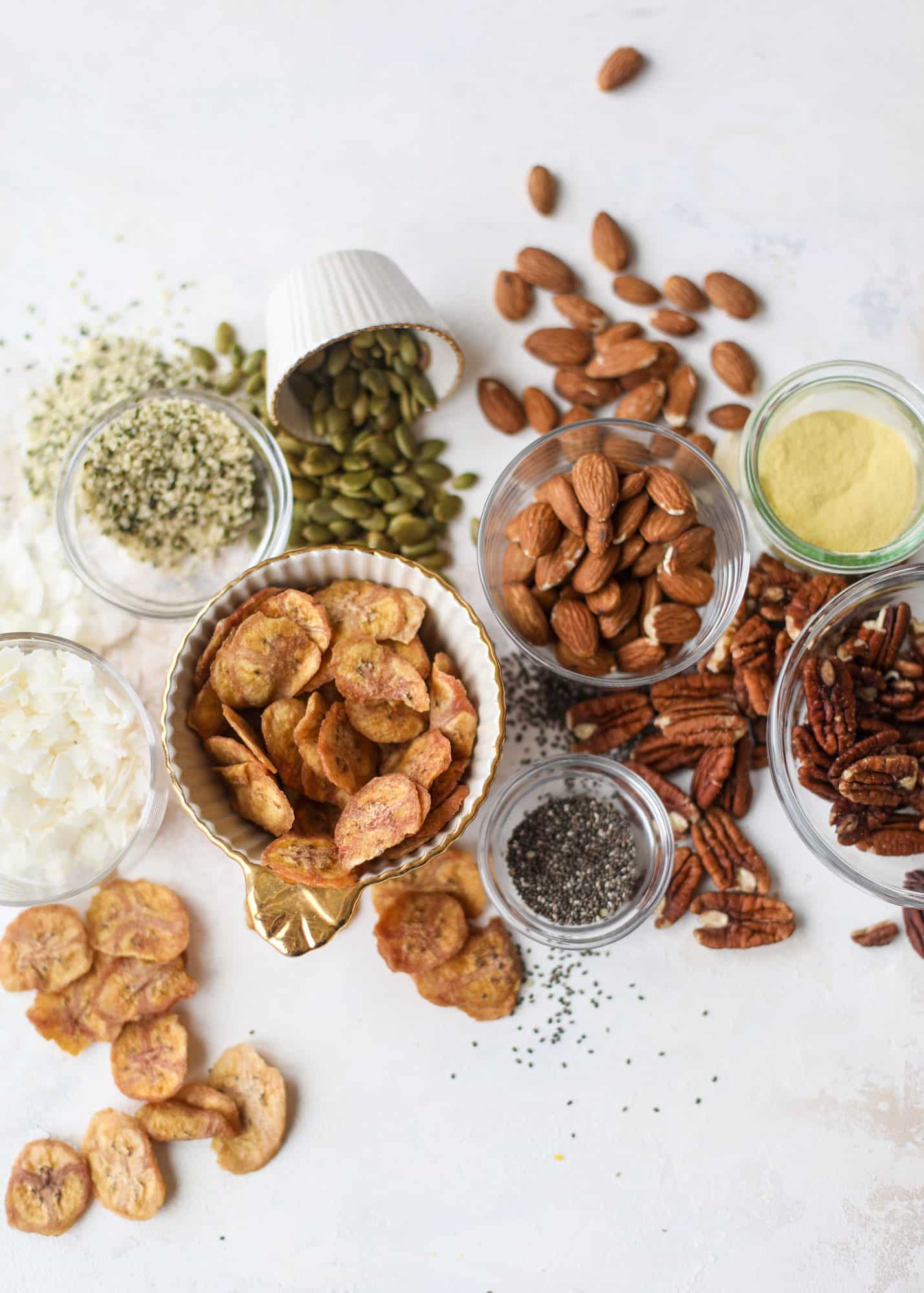 This delicious healthy snack mix is perfect to prep for snacks on the go! It's satisfying, flavorful, both sweet and savory and the best part - is super crunchy. It's full of nuts, some fruit, a bit of coconut, spices, hemp hearts and chia! I howsweeteats.com #healthy #trailmix