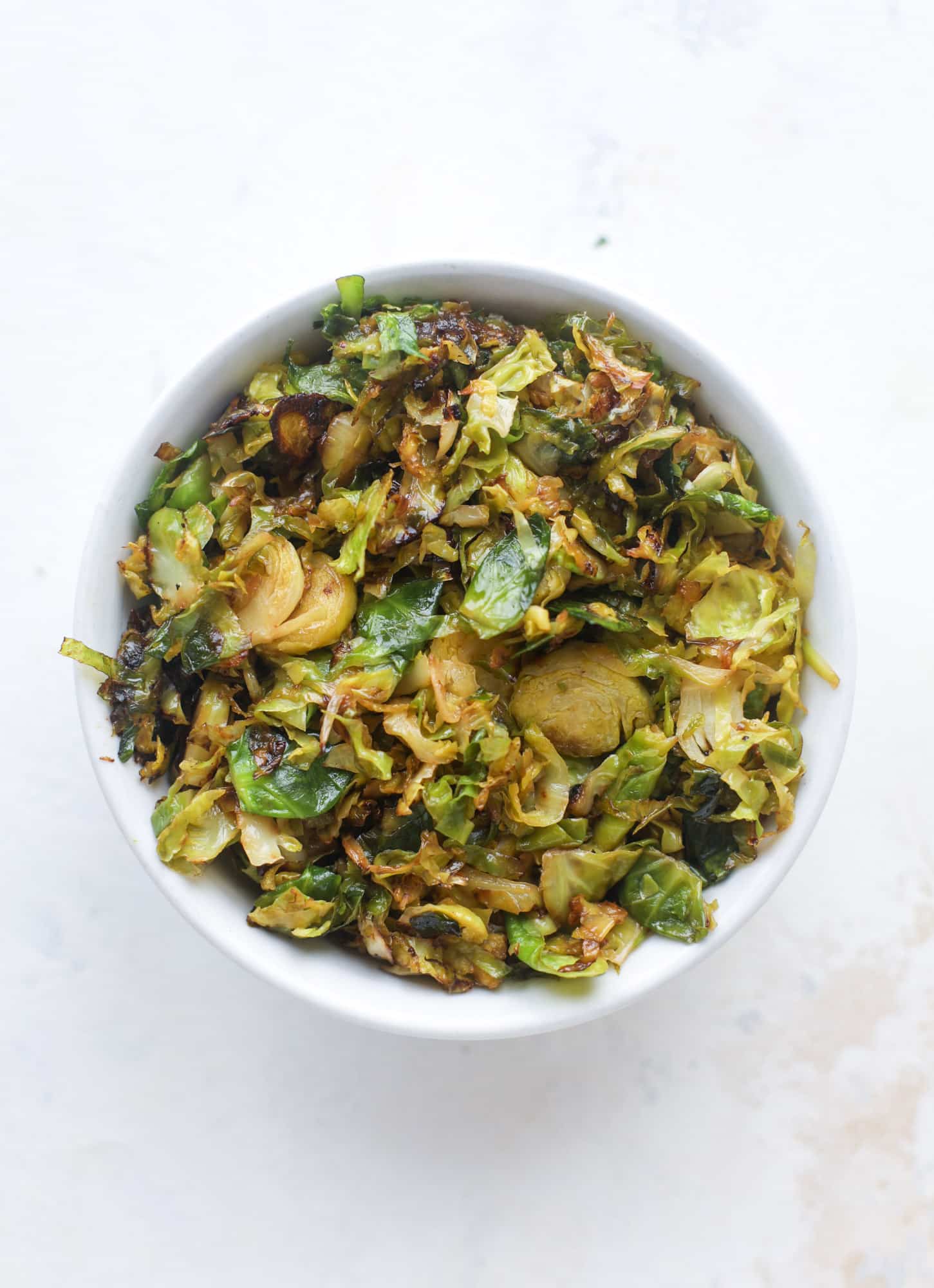 Crispy brussels sprouts toast begins with sourdough bread, melty havarti cheese and caramelized onions. It's high-maintenance toast in the best way possible. I howsweeteats.com