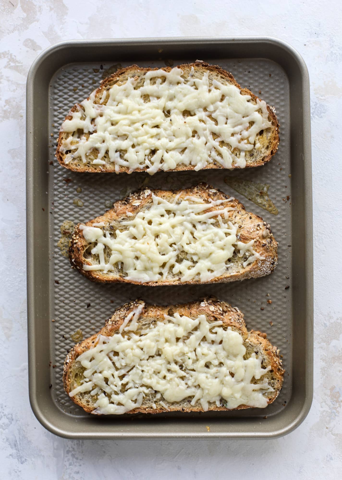 Crispy brussels sprouts toast begins with sourdough bread, melty havarti cheese and caramelized onions. It's high-maintenance toast in the best way possible. I howsweeteats.com