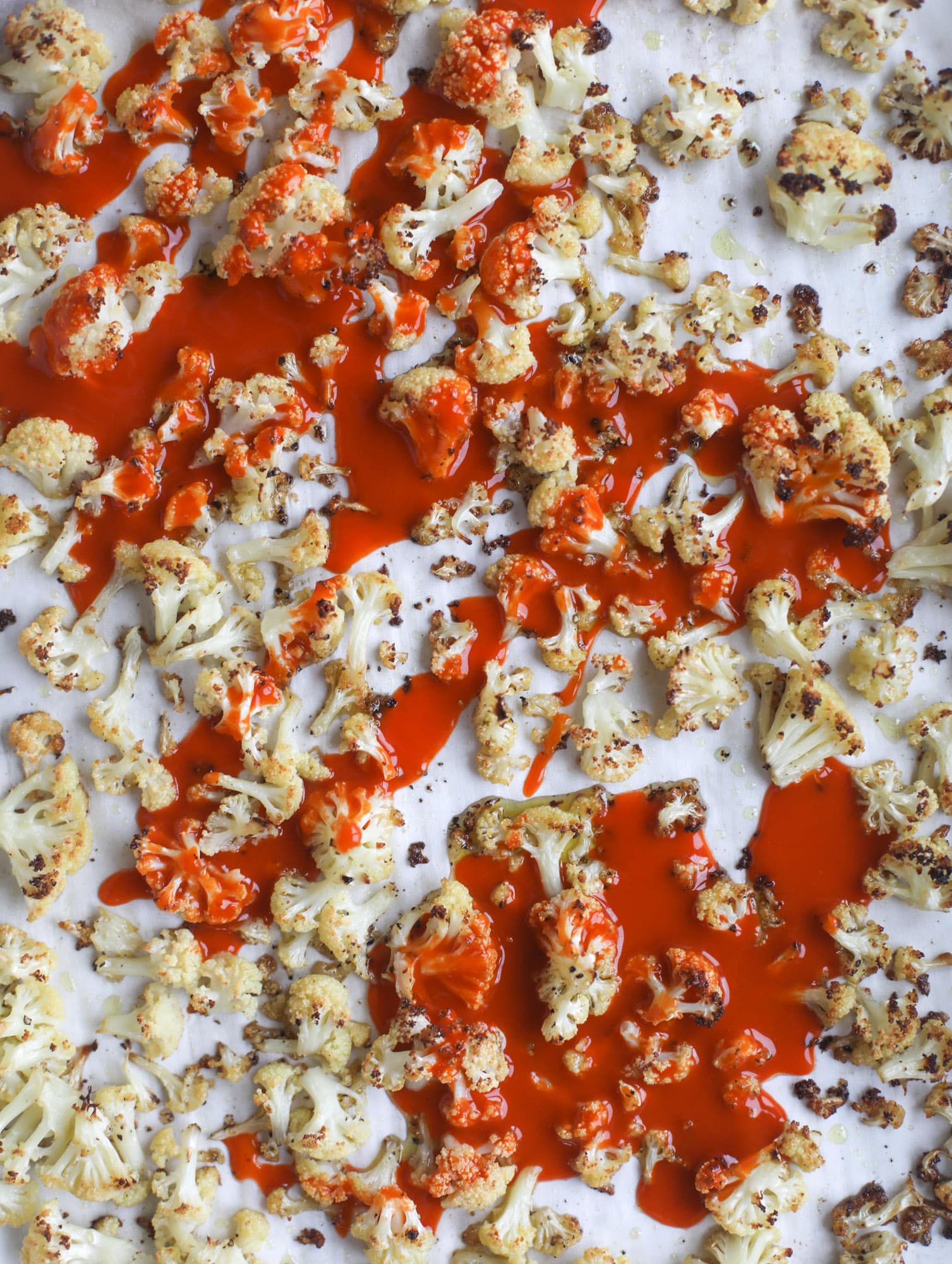 These buffalo cauliflower lettuce wraps are perfect for game day or even a quick weeknight dinner. Roasted cauliflower with buffalo wing sauce, sliced avocado, crumbled blue cheese, scallions, cilantro and chives makes for a flavor explosion! I howsweeteats.com #buffalo #cauliflower