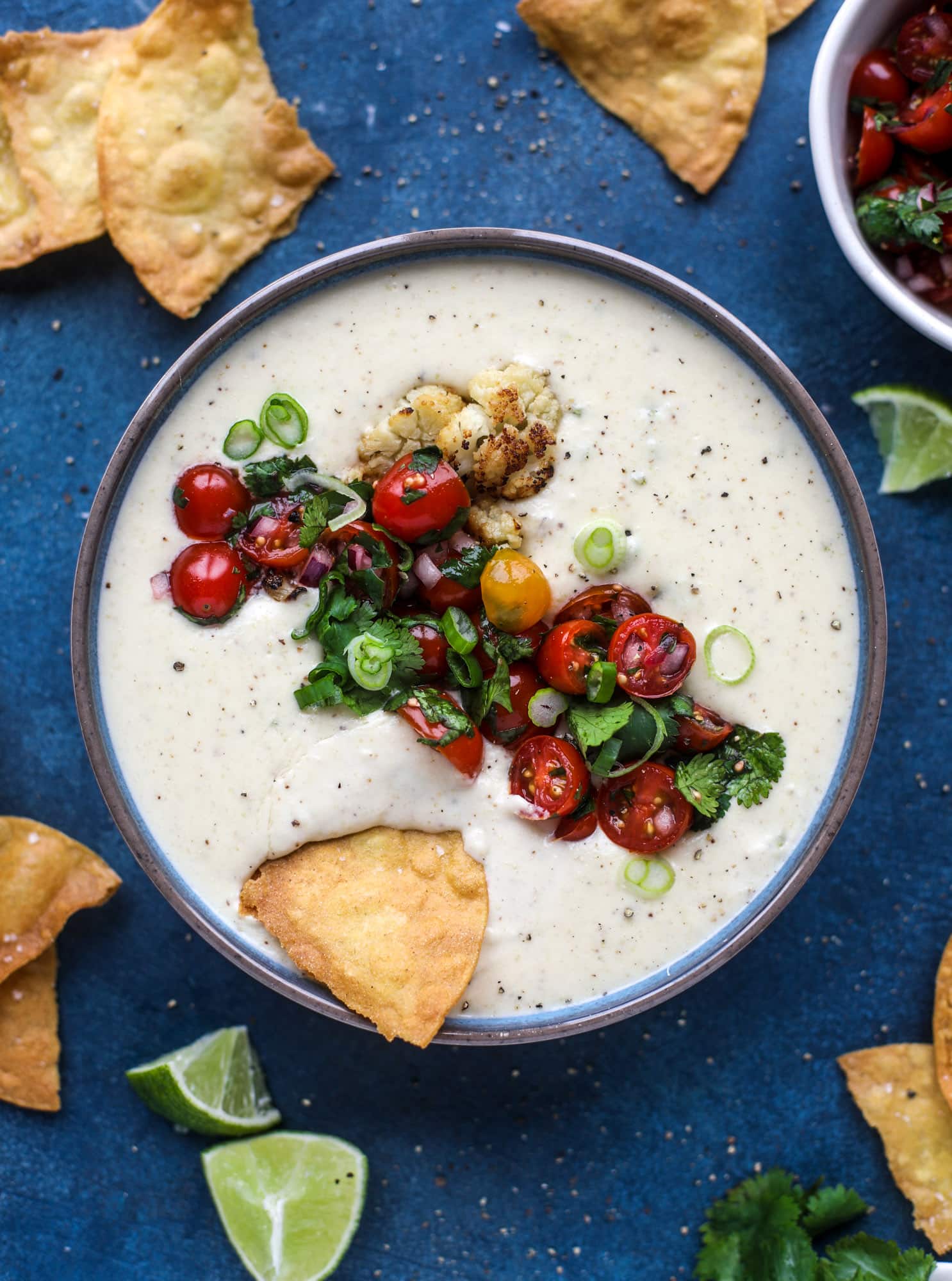 This roasted cauliflower queso has all the deliciousness of regular queso, with roasted cauliflower added in. It's satisfying and tastes like heaven. I howsweeteats.com #cauliflower #queso
