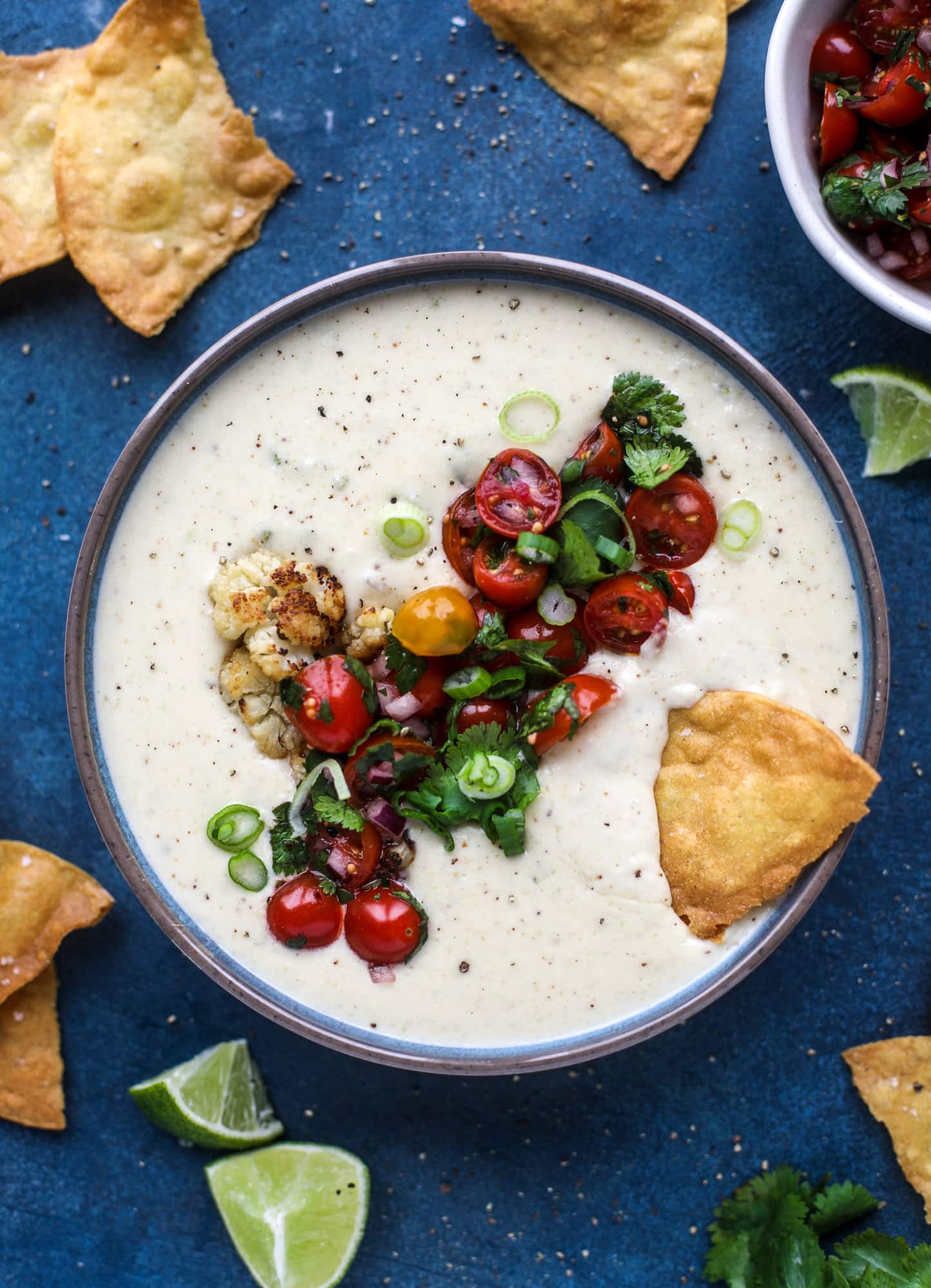 This roasted cauliflower queso has all the deliciousness of regular queso, with roasted cauliflower added in. It's satisfying and tastes like heaven. I howsweeteats.com #cauliflower #queso
