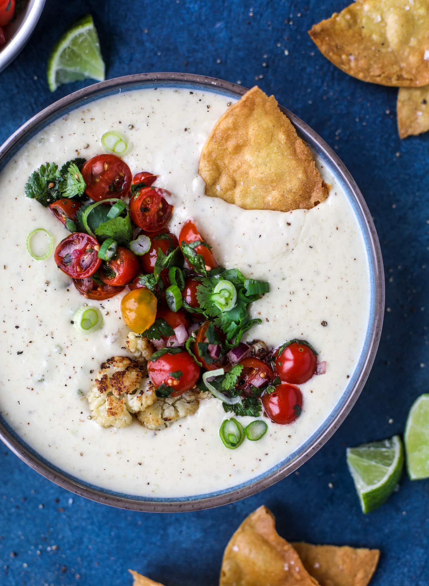This roasted cauliflower queso has all the deliciousness of regular queso, with roasted cauliflower added in. It's satisfying and tastes like heaven. I howsweeteats.com #cauliflower #queso