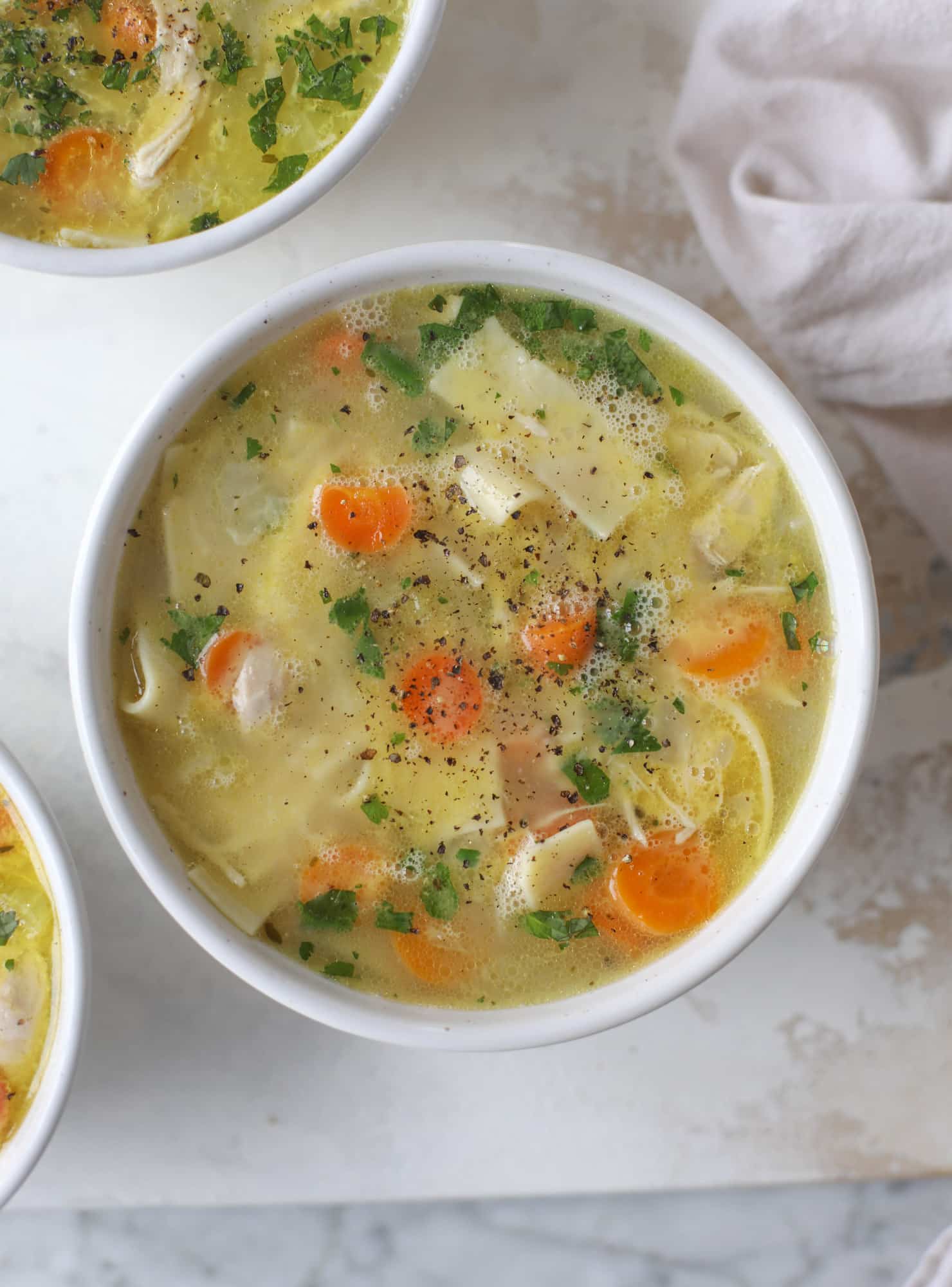 This chicken noodle egg drop soup is the ultimate comfort food! Homemade stock and satisfying ingredients provide the best nourishment and comfort! I howsweeteats.com #chicken #noodlesoup