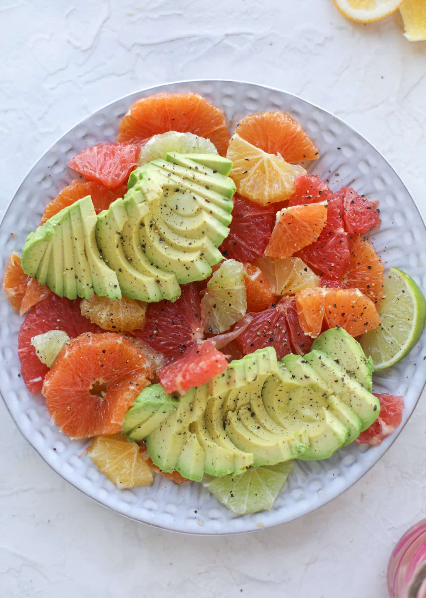 A deliciously fresh and invigorating avocado citrus salad with honey lime vinaigrette. It's creamy, tart, sweet and refreshing! I howsweeteats.com #avocado #citrussalad