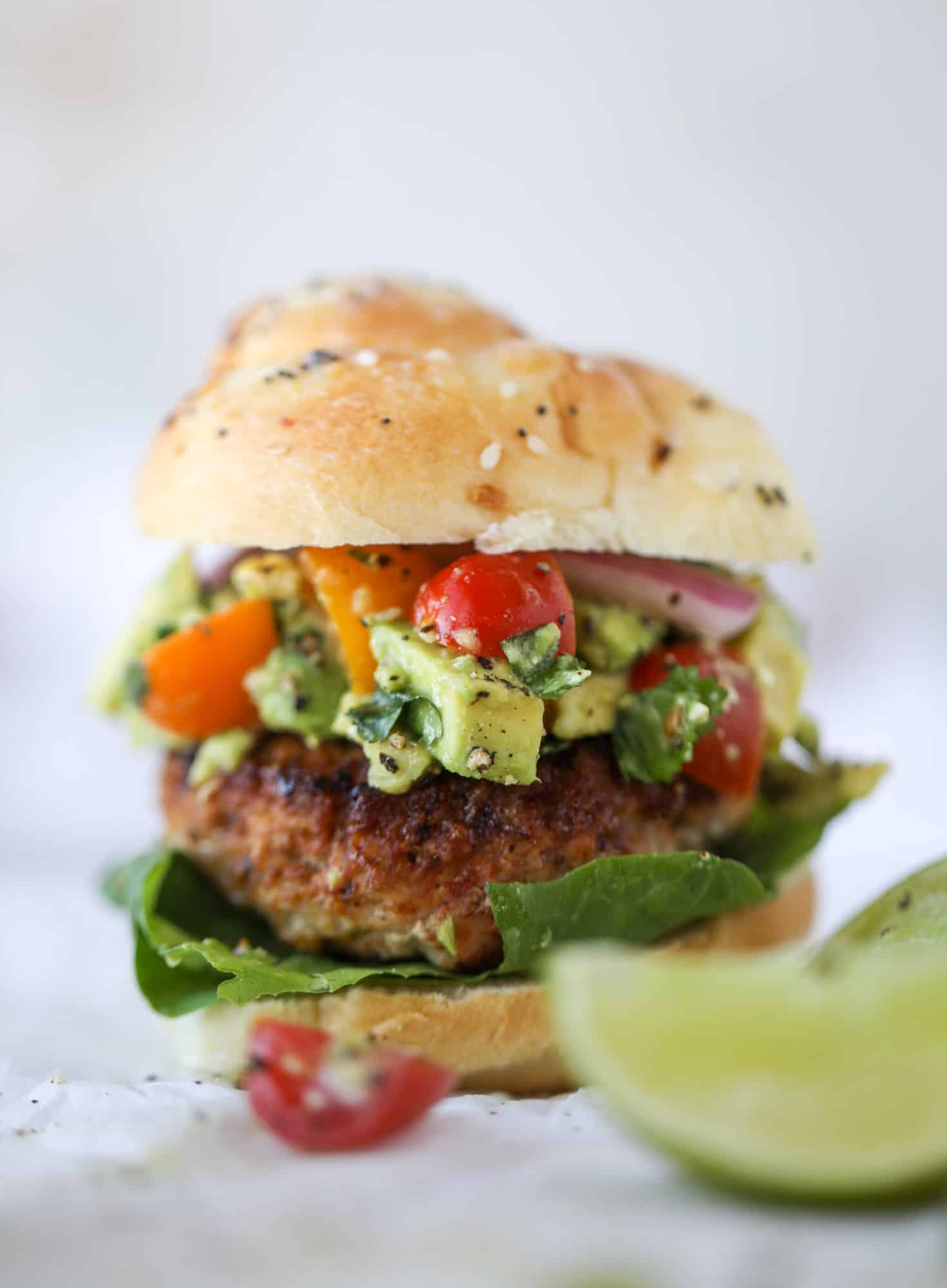 These turkey burgers are full of flavor and topped with a delicious chunky guacamole to take the flavor over the top. The perfect easy dinner! I howsweeteats.com #turkey #burgers