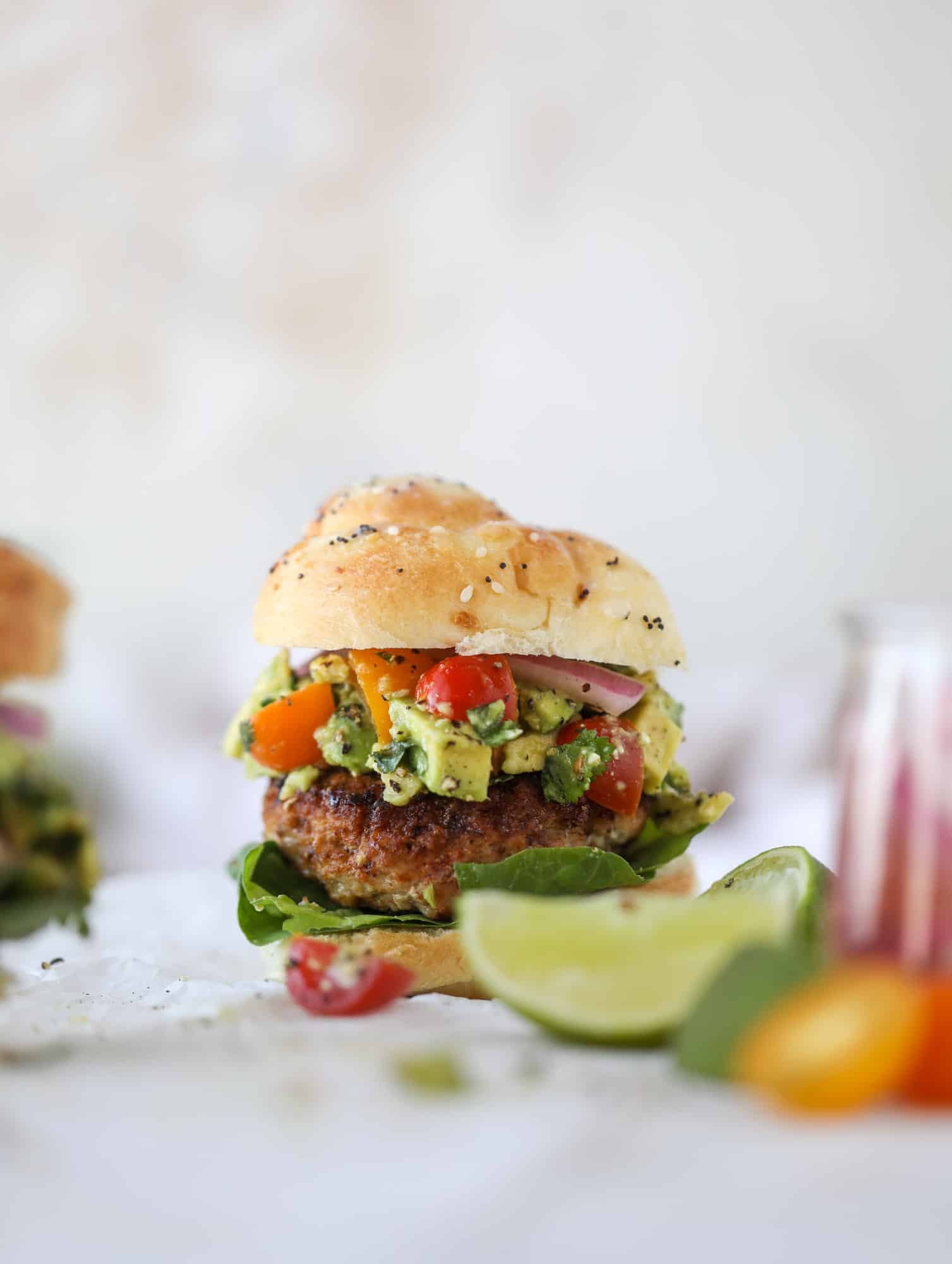 These turkey burgers are full of flavor and topped with a delicious chunky guacamole to take the flavor over the top. The perfect easy dinner! I howsweeteats.com #turkey #burgers