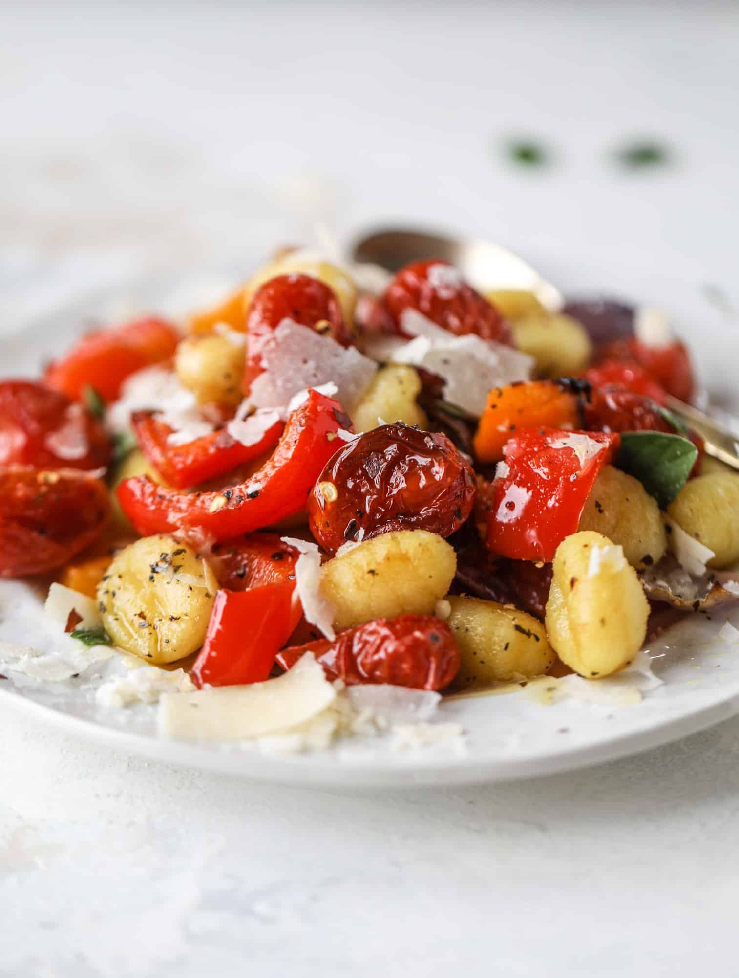 Sheet pan gnocchi is an easy meal that the whole family will love! Toasted gnocchi along with burst tomatoes and caramelized peppers makes the best dinner. I howsweeteats.com #sheetpan #gnocchi