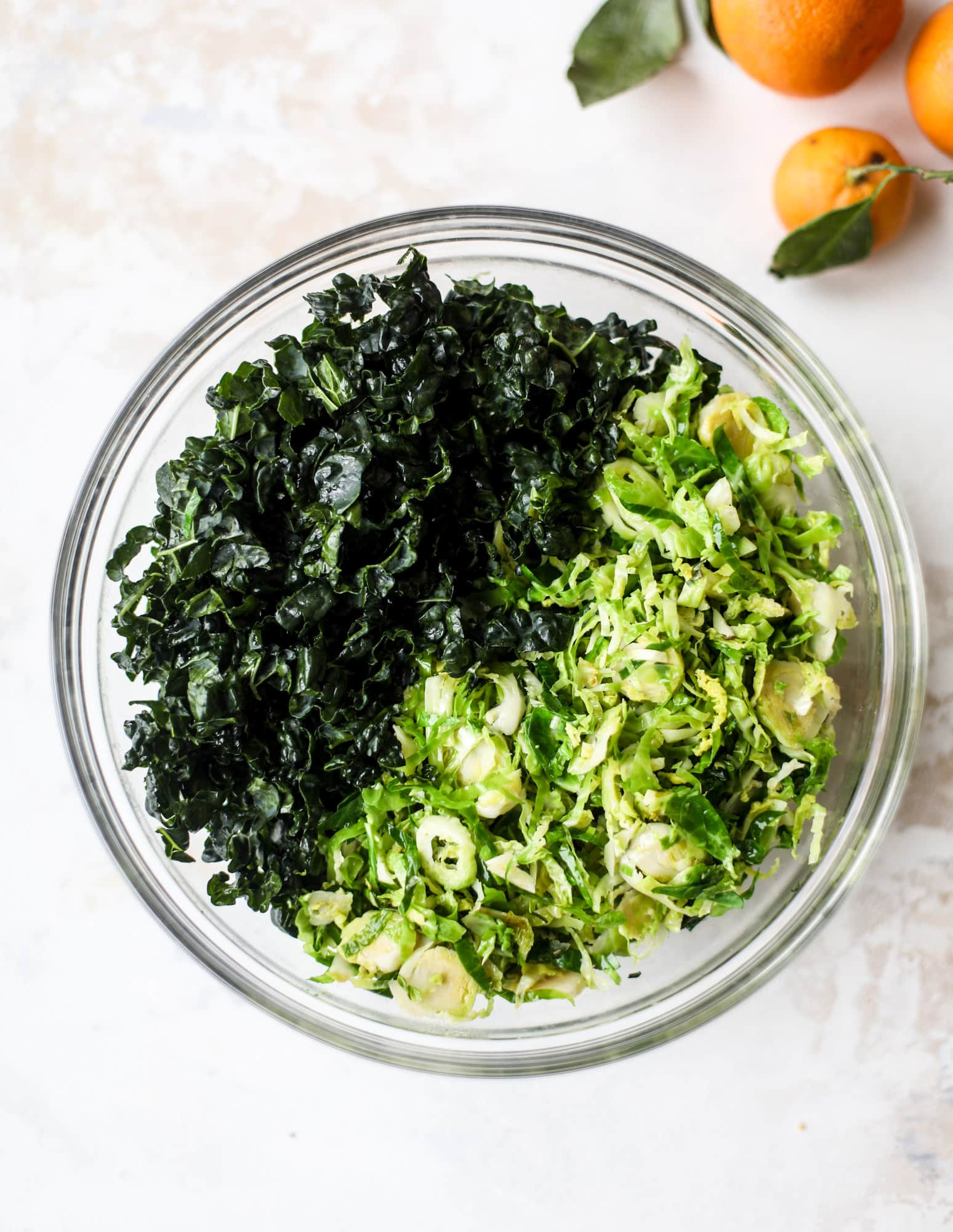 This winter crunch salad is loaded with tons of delicious, crunchy seasonal ingredients. A base of brussels sprouts and kale is topped with sliced apples, satsuma wedges, pomegranate arils, toasted walnuts and savory flaked coconut crunch. Delish! I howsweeteats.com #winter #salad