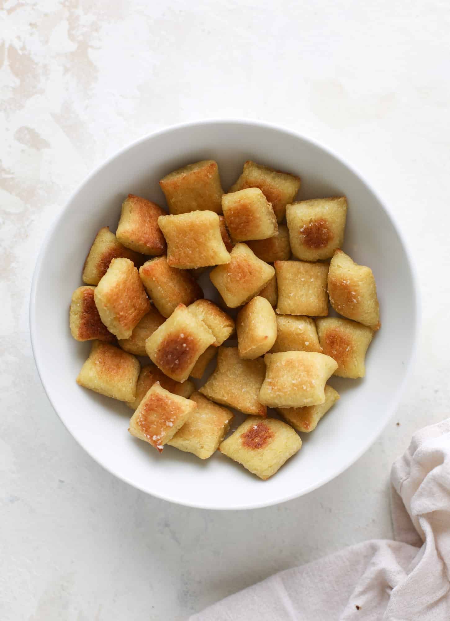 Homemade cauliflower gnocchi that tastes just like the Trader Joe's version! It's made with cauliflower, comes together fast and is super easy! I howsweeteats.com #cauliflower #gnocchi