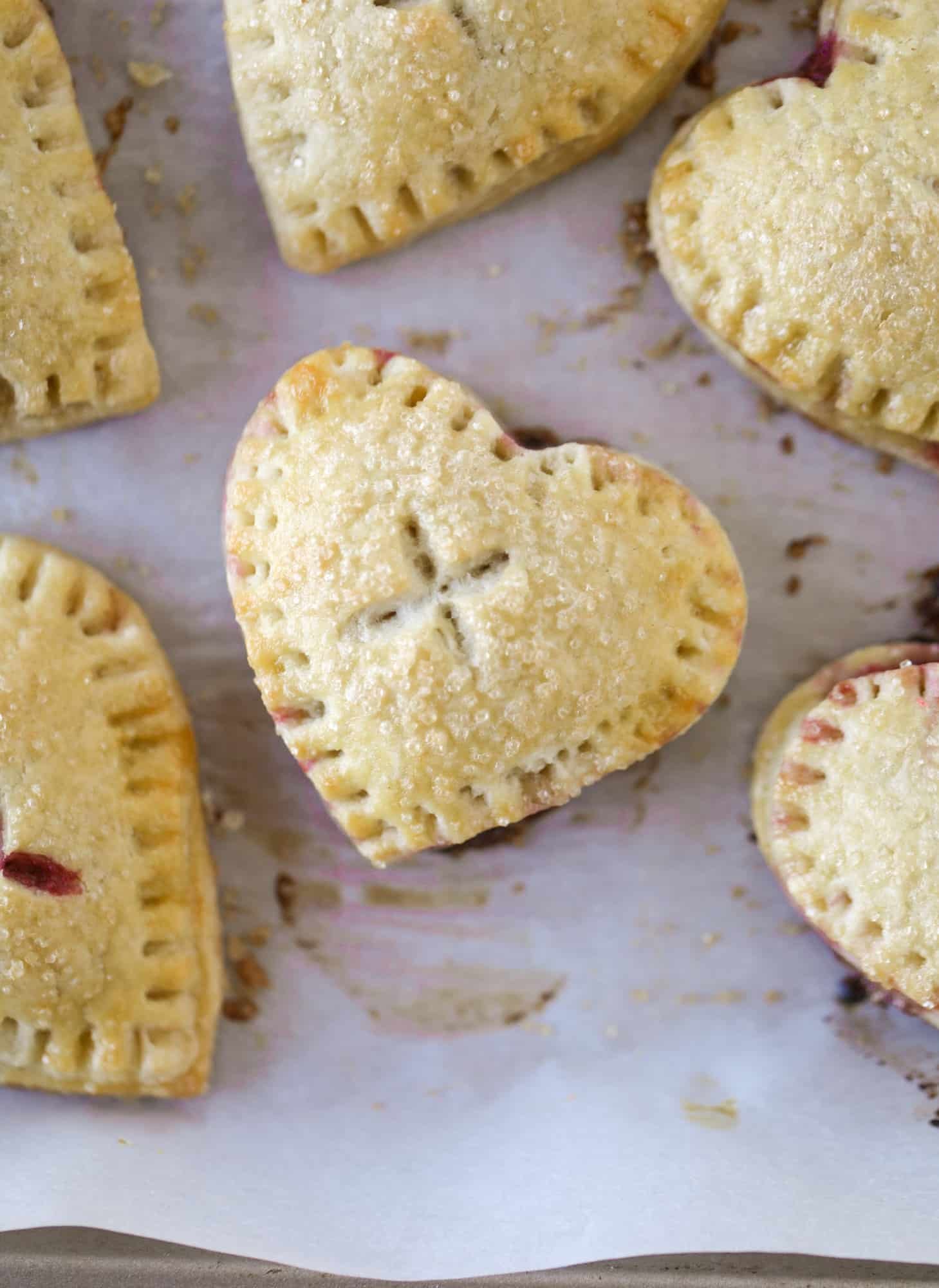 These adorable mini heart pies are filled with a homemade raspberry compote and creamy, chocolatey nutella. So fun and easy to make! I howsweeteats.com #heart #pie