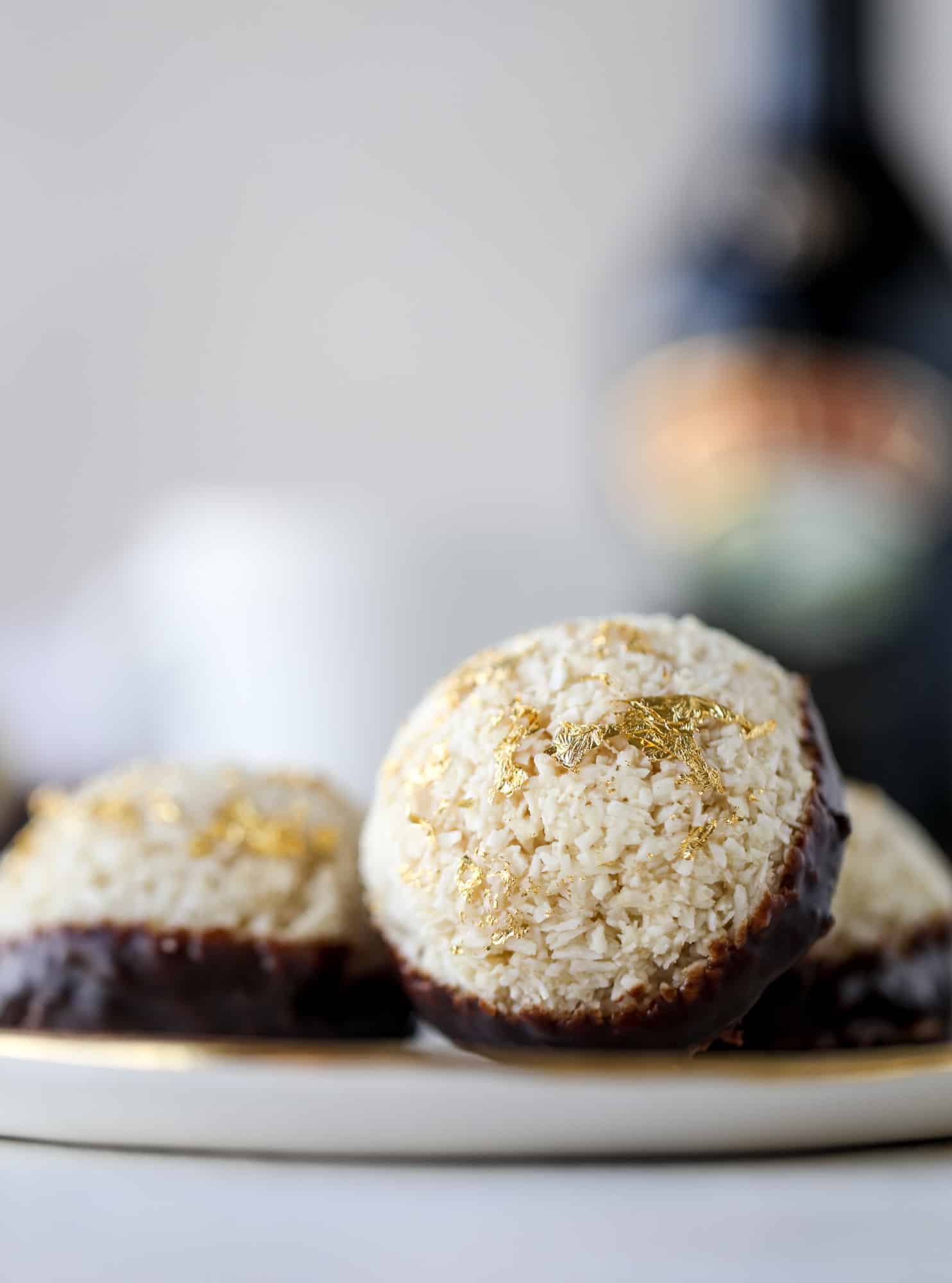 Classic chewy, slightly gooey coconut macaroons dipped in an irish cream chocolate ganache. Easy to make and gluten free too! I howsweeteats.com #irishcream #coconutmacaroons