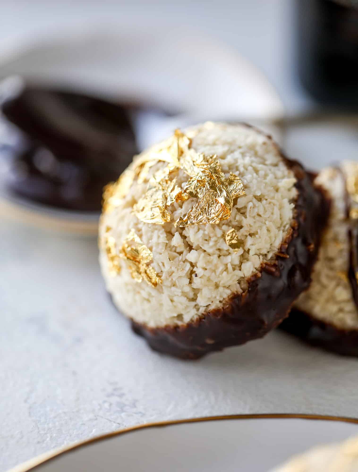 Classic chewy, slightly gooey coconut macaroons dipped in an irish cream chocolate ganache. Easy to make and gluten free too! I howsweeteats.com #irishcream #coconutmacaroons