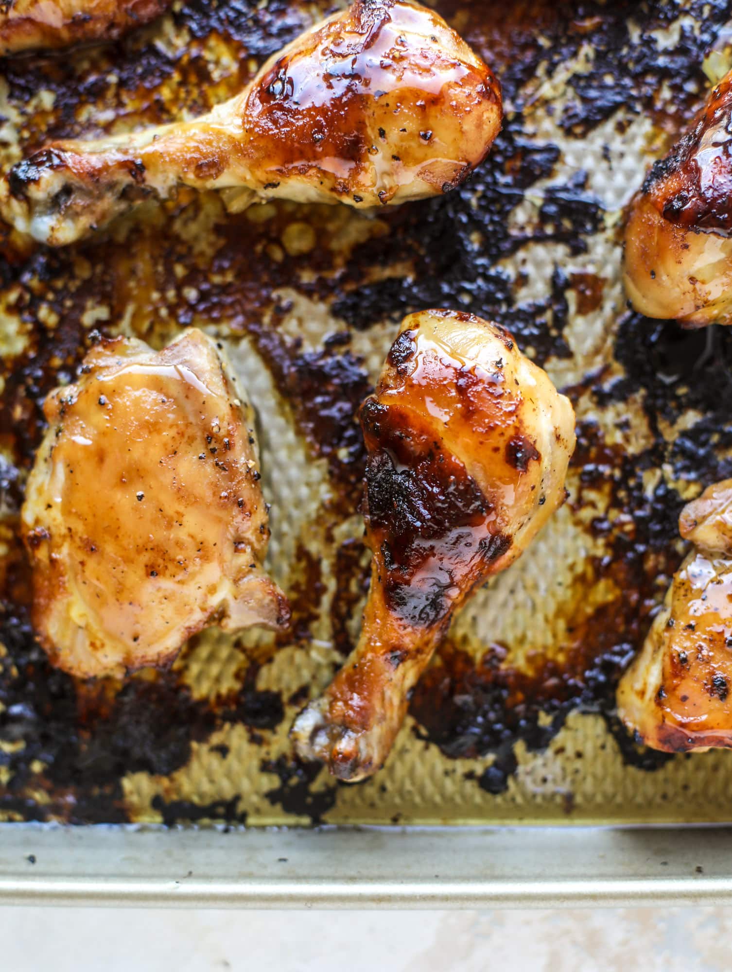 This sticky chicken recipe is made on a sheet pan and roasted until flavorfor and sticky with sauce, then served with pineapple salsa. It's the best! I howsweeteats.com #sticky #chicken