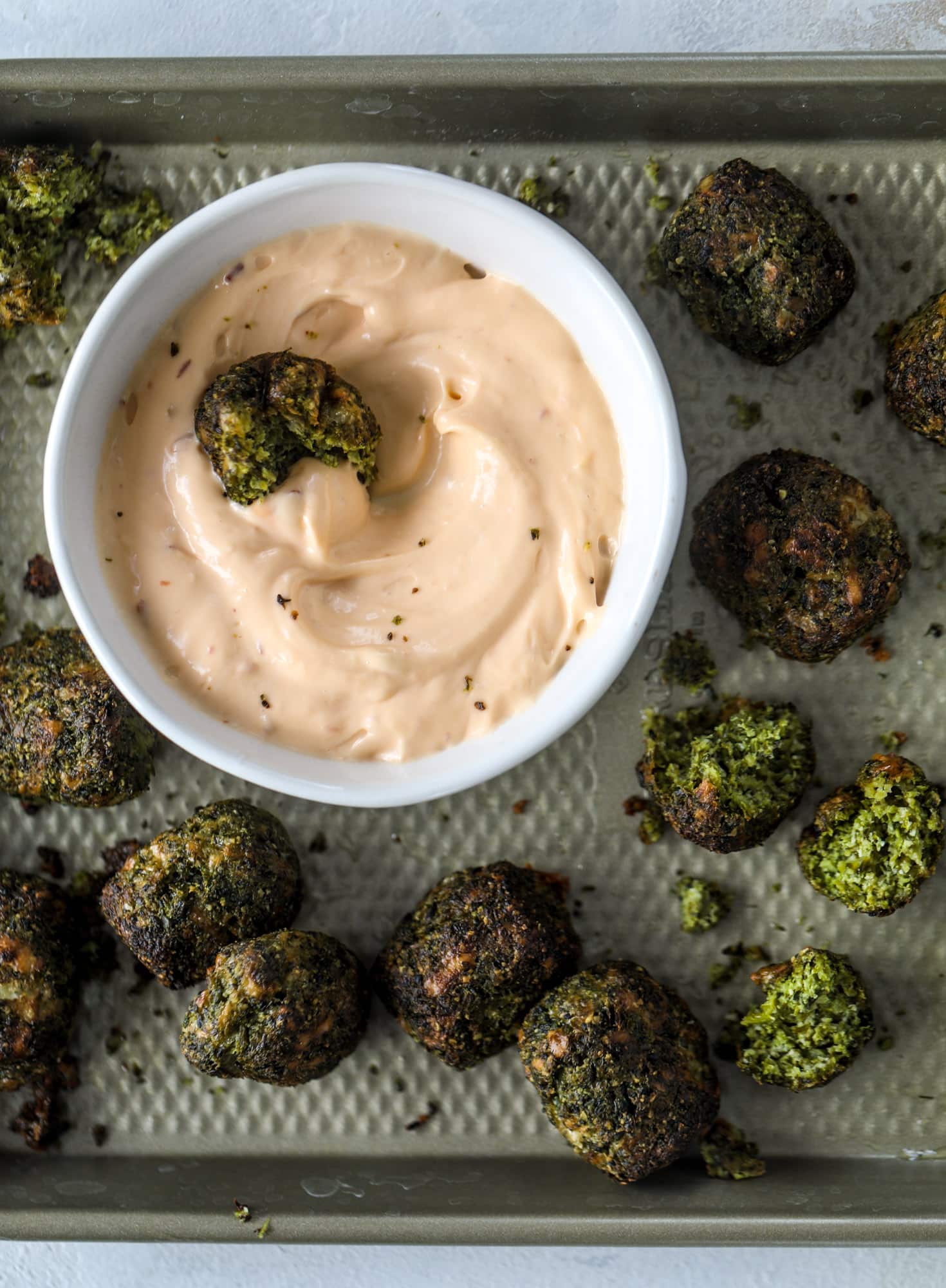 These broccoli cheddar tots are baked, crispy bites of broccoli and sharp cheddar cheese! So delicious and easy to throw together too. I howsweeteats.com #broccolicheddar #tots