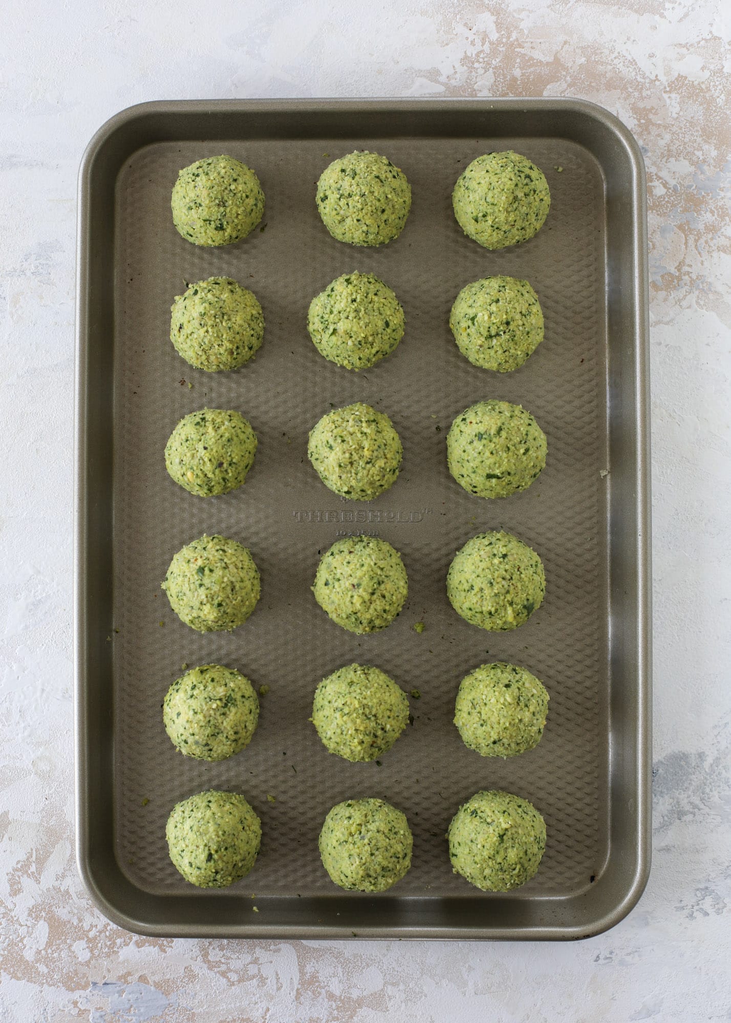 Green goddess falafel is hearty and flavorful, served over the creamiest cauliflower hummus, with tomatoes, olive, cucumbers and feta. Yum! I howsweeteats.com #falafel #cauliflowerhummus