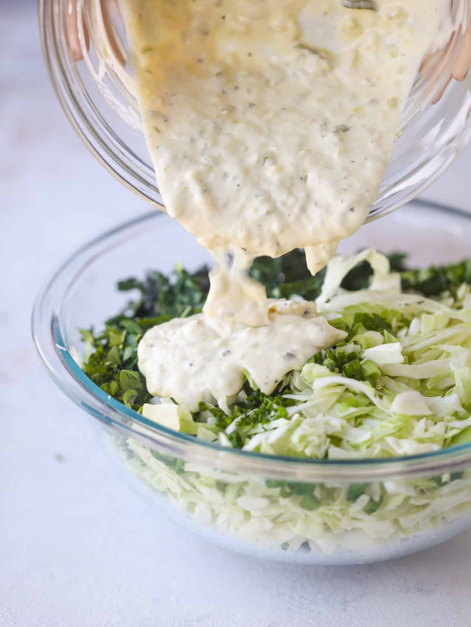 A light and crispy fish sandwich made with a simple beer batter and topped with a hearty, creamy kale cole slaw. Loaded with flavor! I howsweeteats.com #crispyfish #sandwich