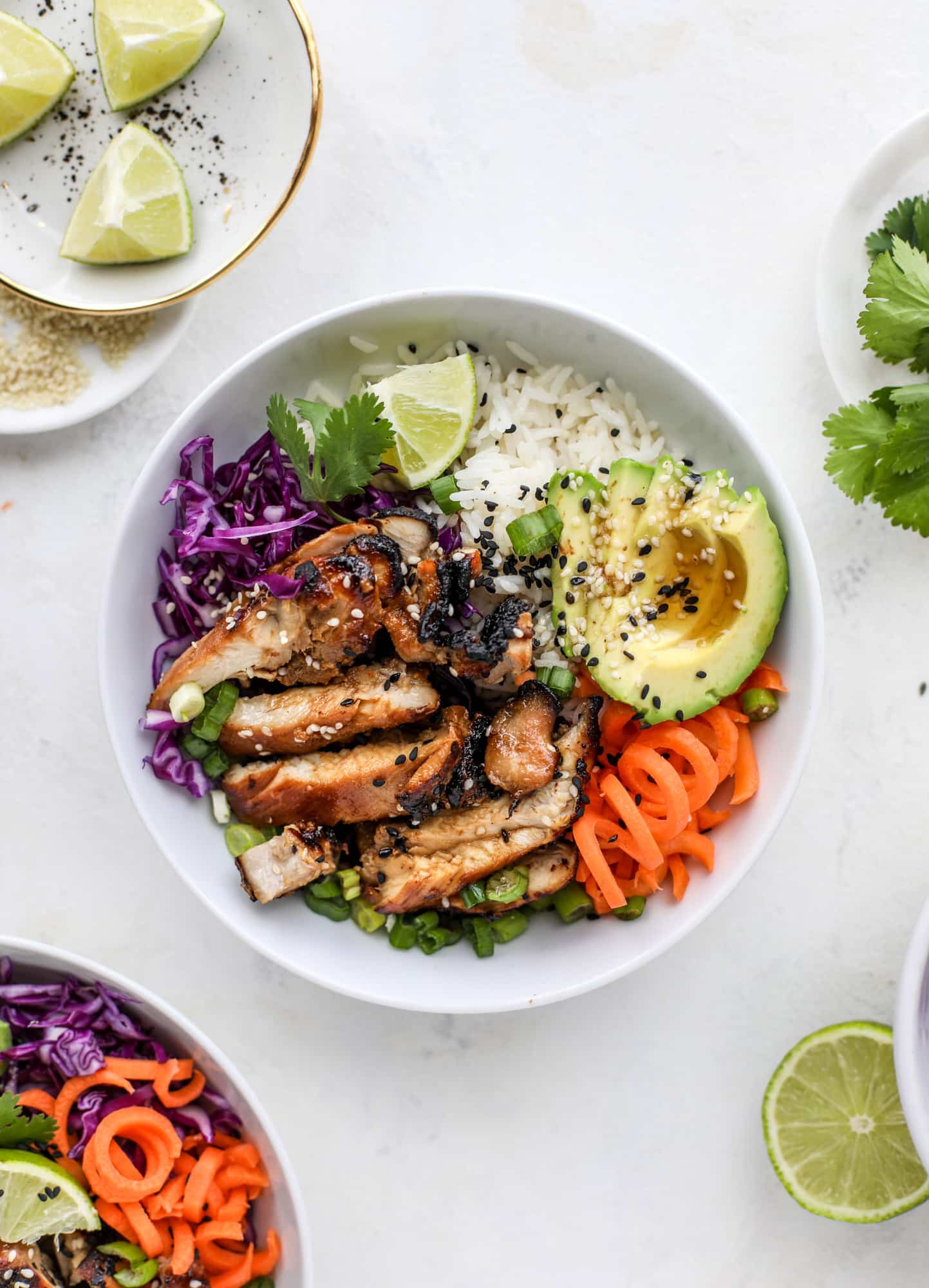 Korean chicken bowls are loaded with flavor: toasted sesame, soy sauce and lime come together over coconut rice and avocado to create a delicious meal! I howsweeteats.com #korean #chicken