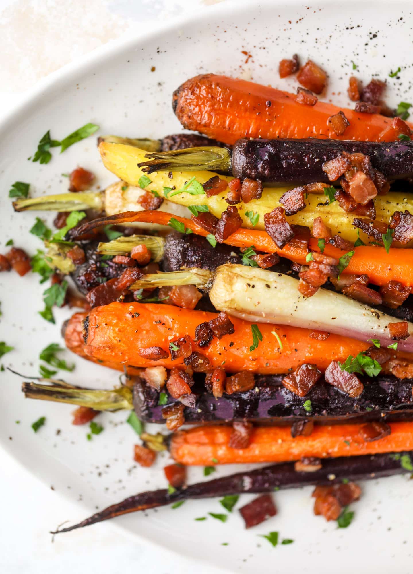 Sweet carrots are drizzled with bacon fat and chopped bacon, then roasted until they are tender, sweet and caramely. So much flavor!