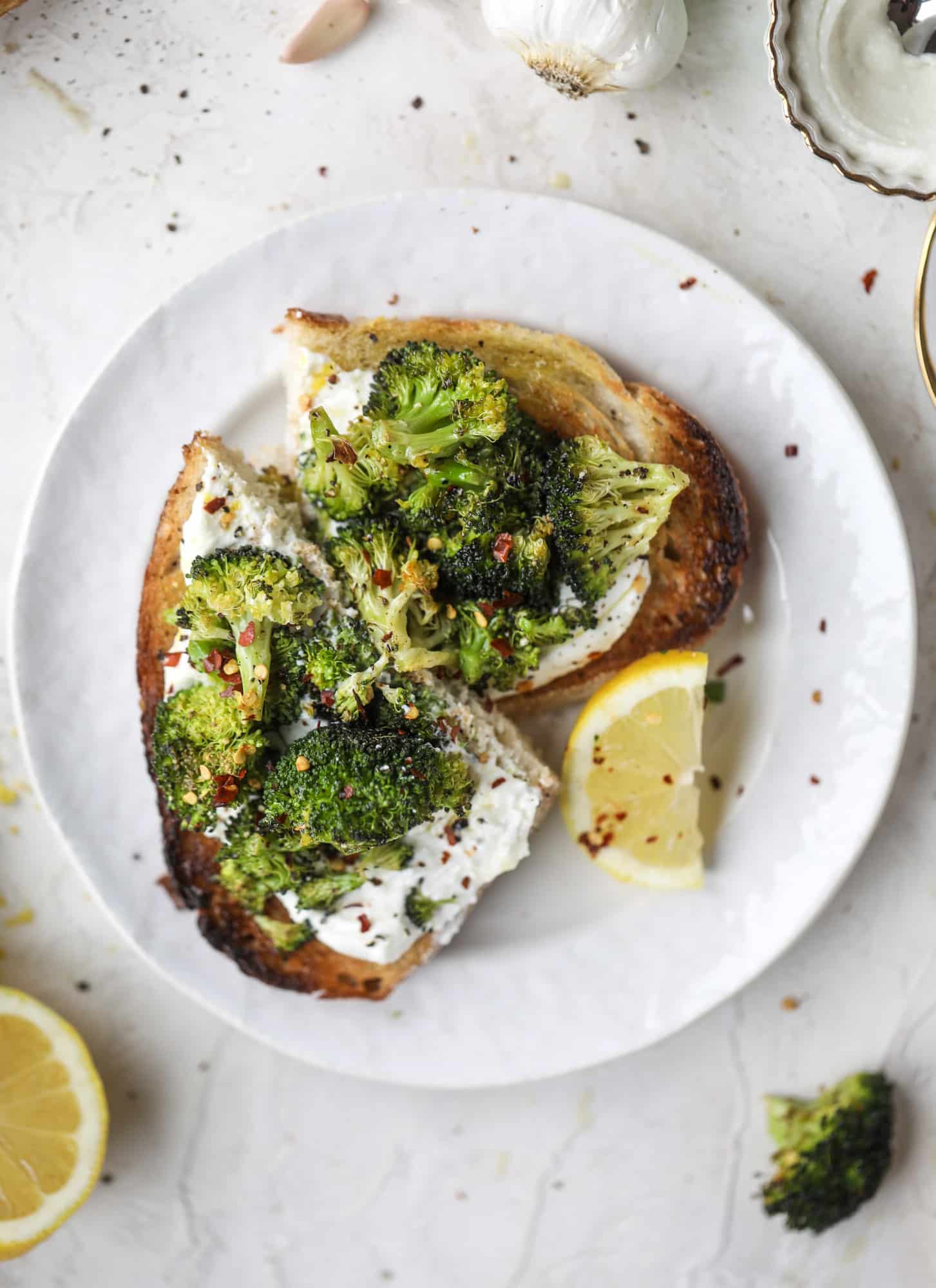 Broccoli toast is the best way to sneak in some veggies! Toasted sourdough with ricotta and roasted broccoli, topped with lemon and crushed red pepper. 