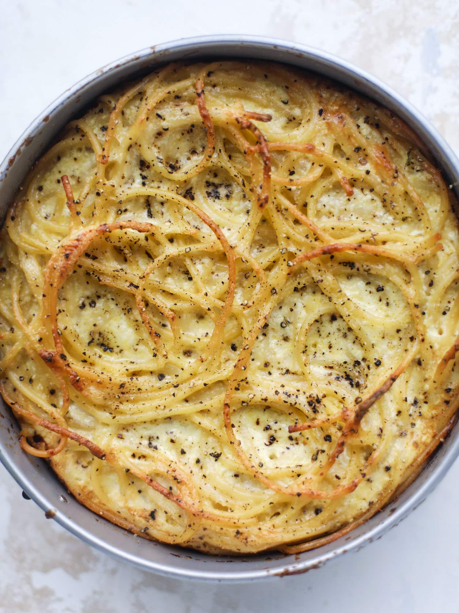 Hello lover! Cacio e pepe pie is made with parmigiano-reggiano cheese, black pepper and bucatini pasta. Baked until cheese and bubbly, it's to die for.