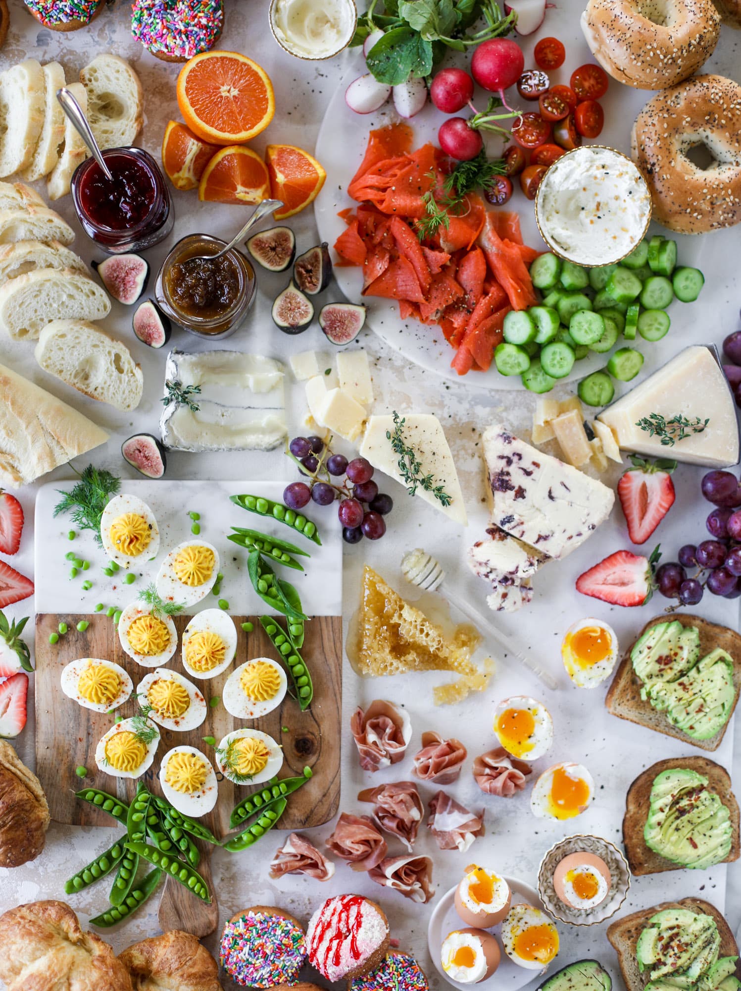 The highlight of this Easter brunch board are the deviled eggs and soft boiled eggs! Add some avocado toast, donuts and bloody marys and you've arrived. I howsweeteats.com #brunch #board