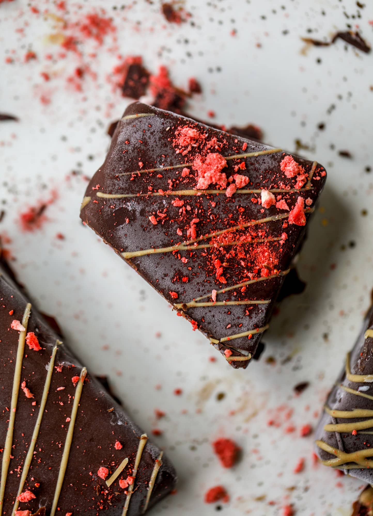 These frozen peanut butter jelly bars are super easy and made with an oatmilk frozen dessert, then covered in a dark chocolate shell. Delish! 