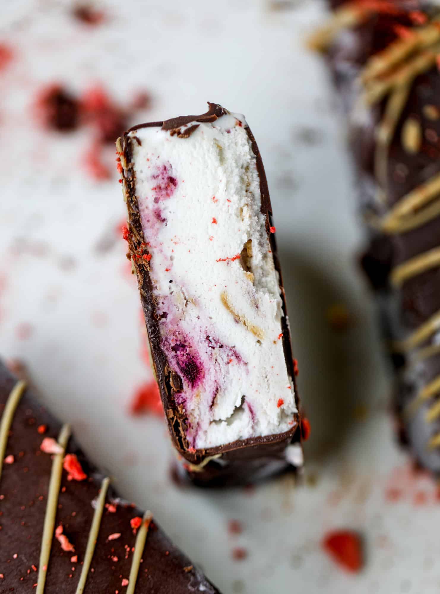 These frozen peanut butter jelly bars are super easy and made with an oatmilk frozen dessert, then covered in a dark chocolate shell. Delish! 