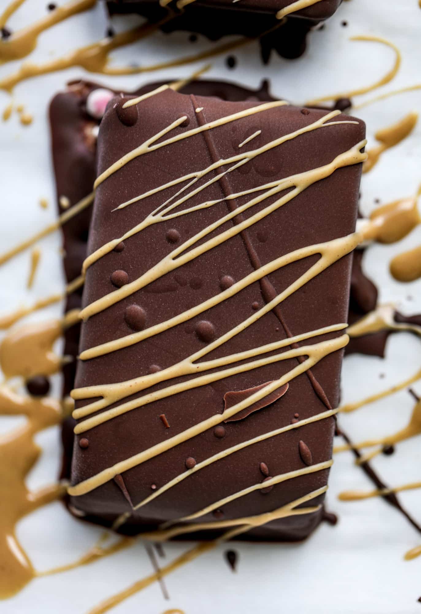 These frozen peanut butter jelly bars are super easy and made with an oatmilk frozen dessert, then covered in a dark chocolate shell. Delish! 