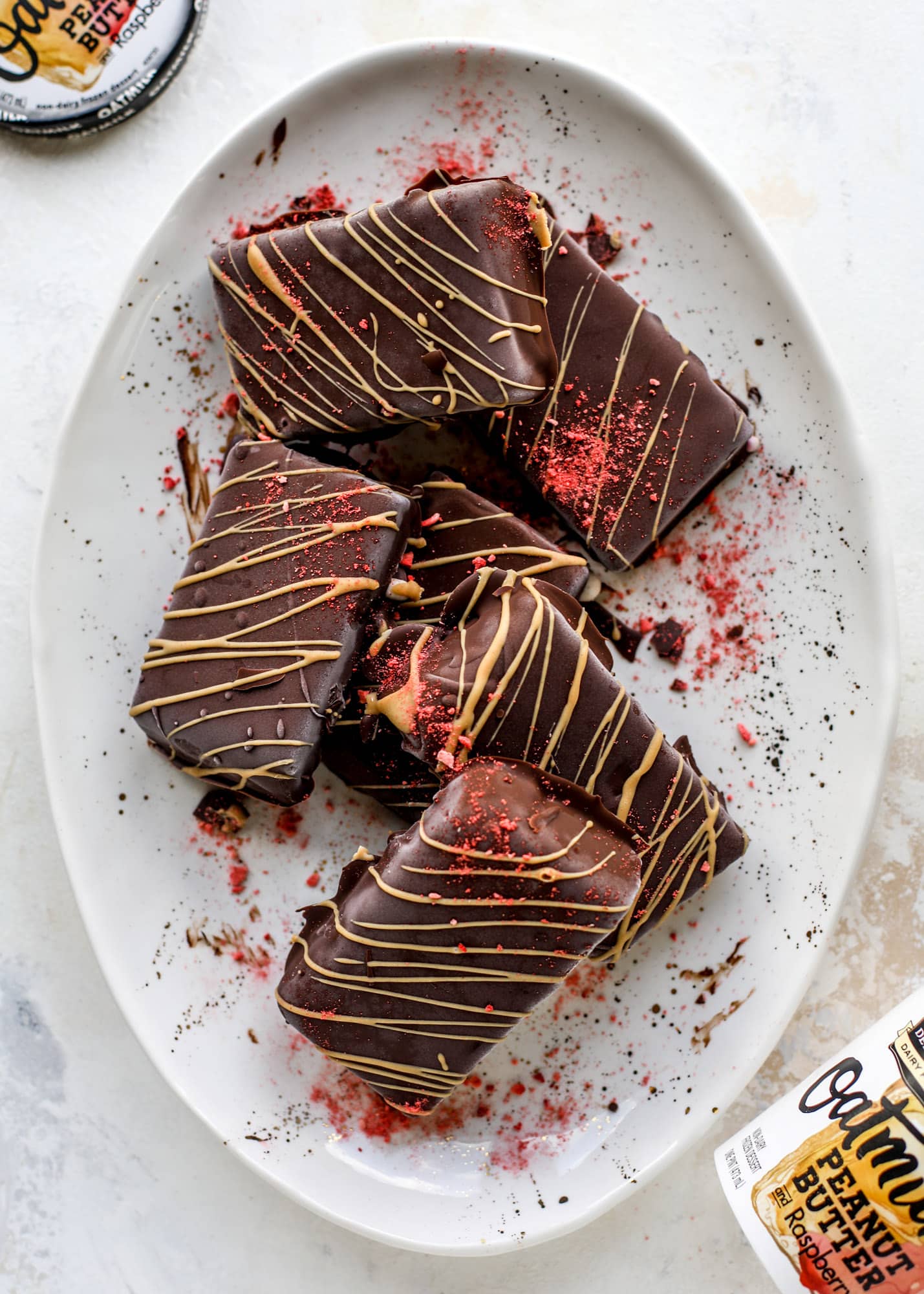 These frozen peanut butter jelly bars are super easy and made with an oatmilk frozen dessert, then covered in a dark chocolate shell. Delish! 