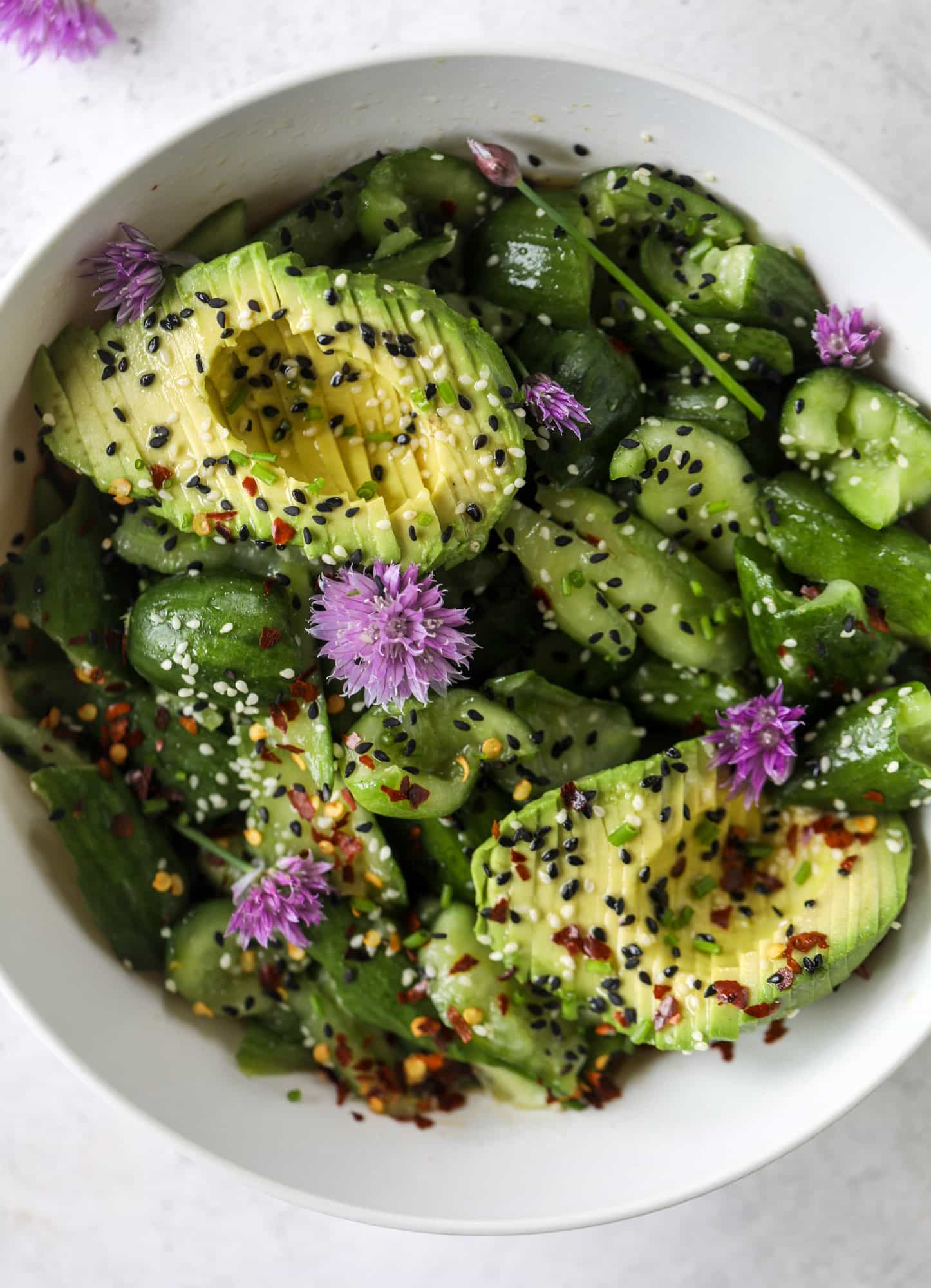This smashed cucumber salad is so refreshing and perfect for summer! Served with avocado, toasted sesame oil and chives, it's ridiculously flavorful.