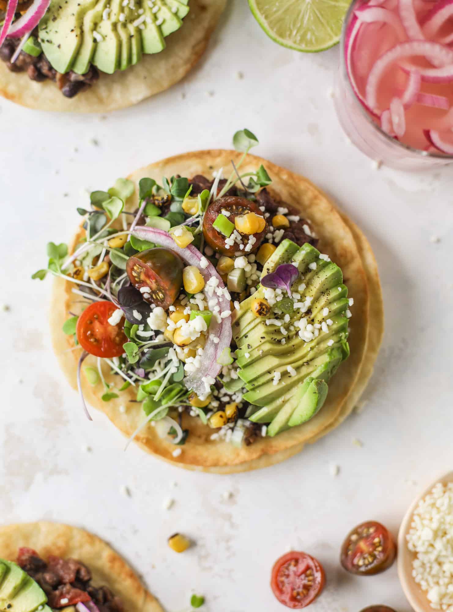 These saucy black bean tostadas are super flavorful and easy for a weeknight meal. Crunchy tortillas topped with beans and tons of veggies. Delish!