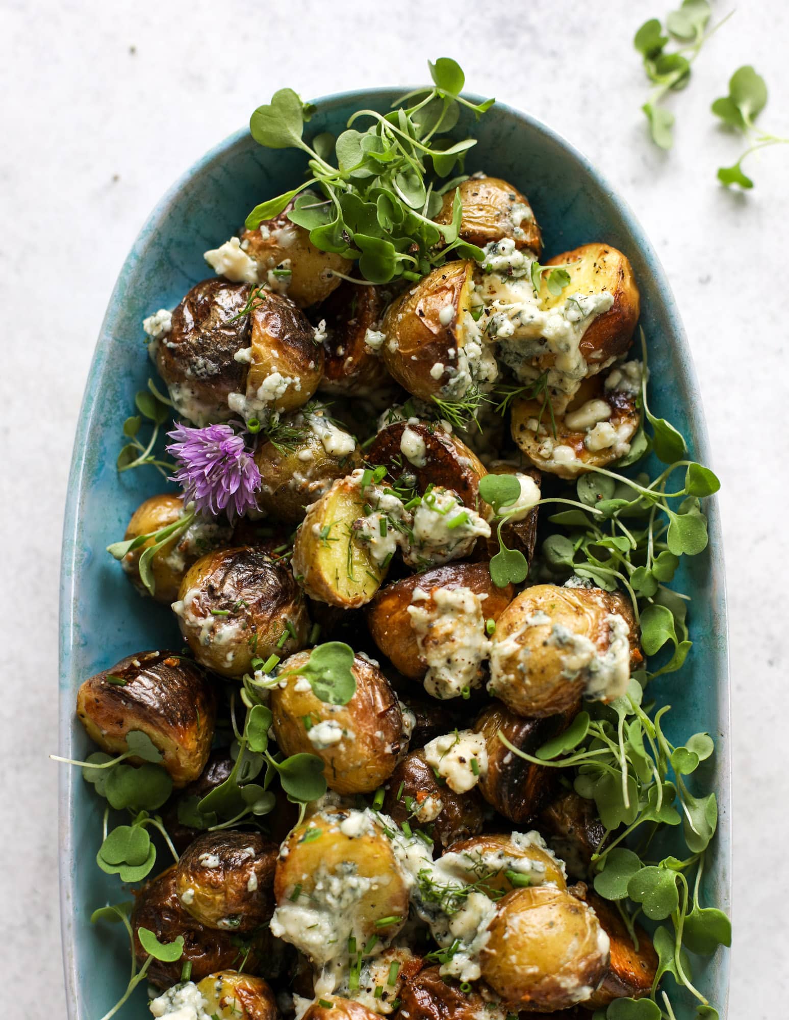 These grilled gorgonzola potatoes are loaded with flavor! Crispy, crunchy grilled bab golds topped with creamy blue cheese and fresh herbs.